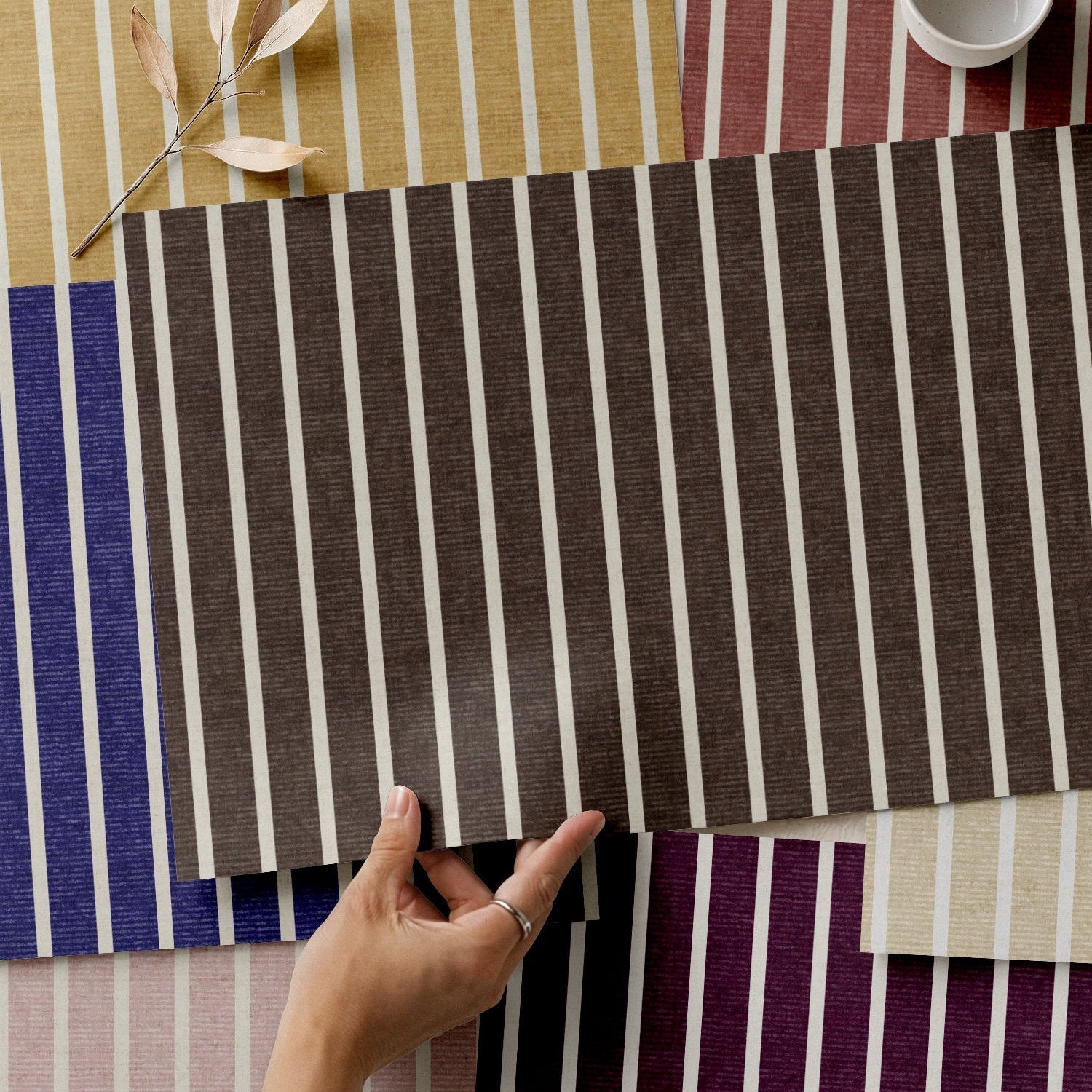 A selection of custom wallpaper samples showing various colors and stripes, illustrating what is custom wallpaper.