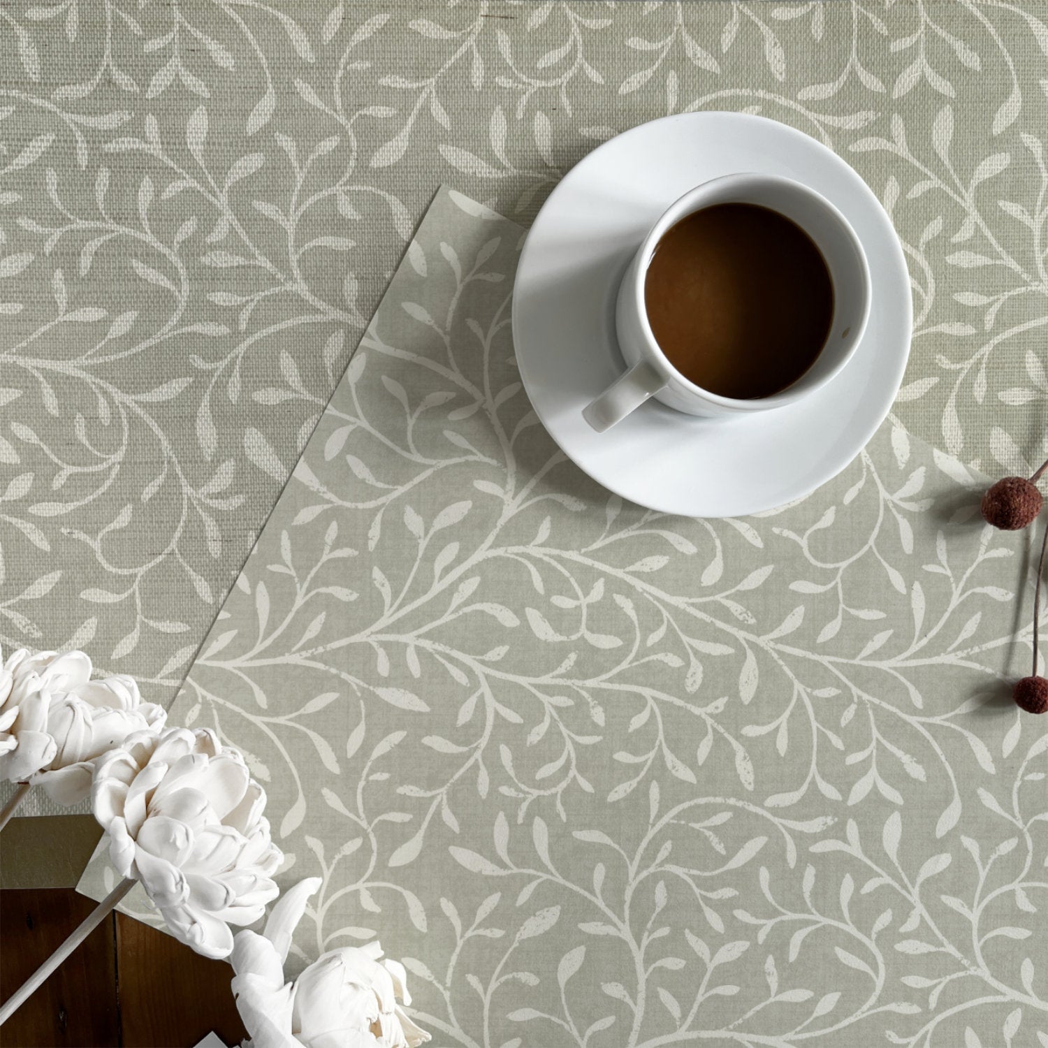 two wallpaper samples side by side showing the difference in texture of natural grasscloth wallpaper and peel and stick