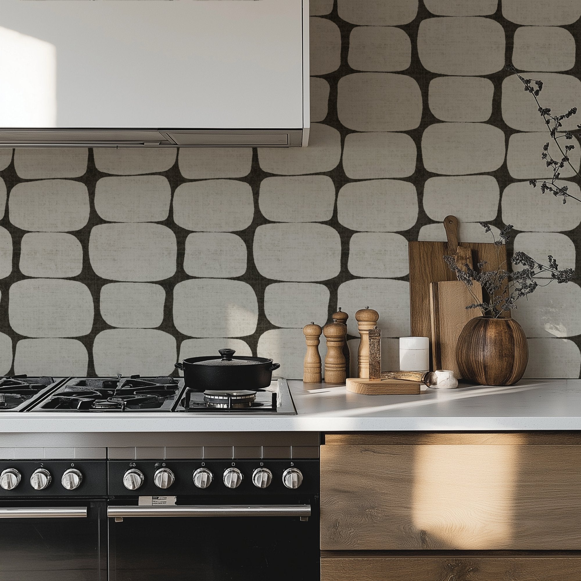Mid-century modern geometric wallpaper in a contemporary kitchen with gas hob, wooden cabinets, and neutral décor.
