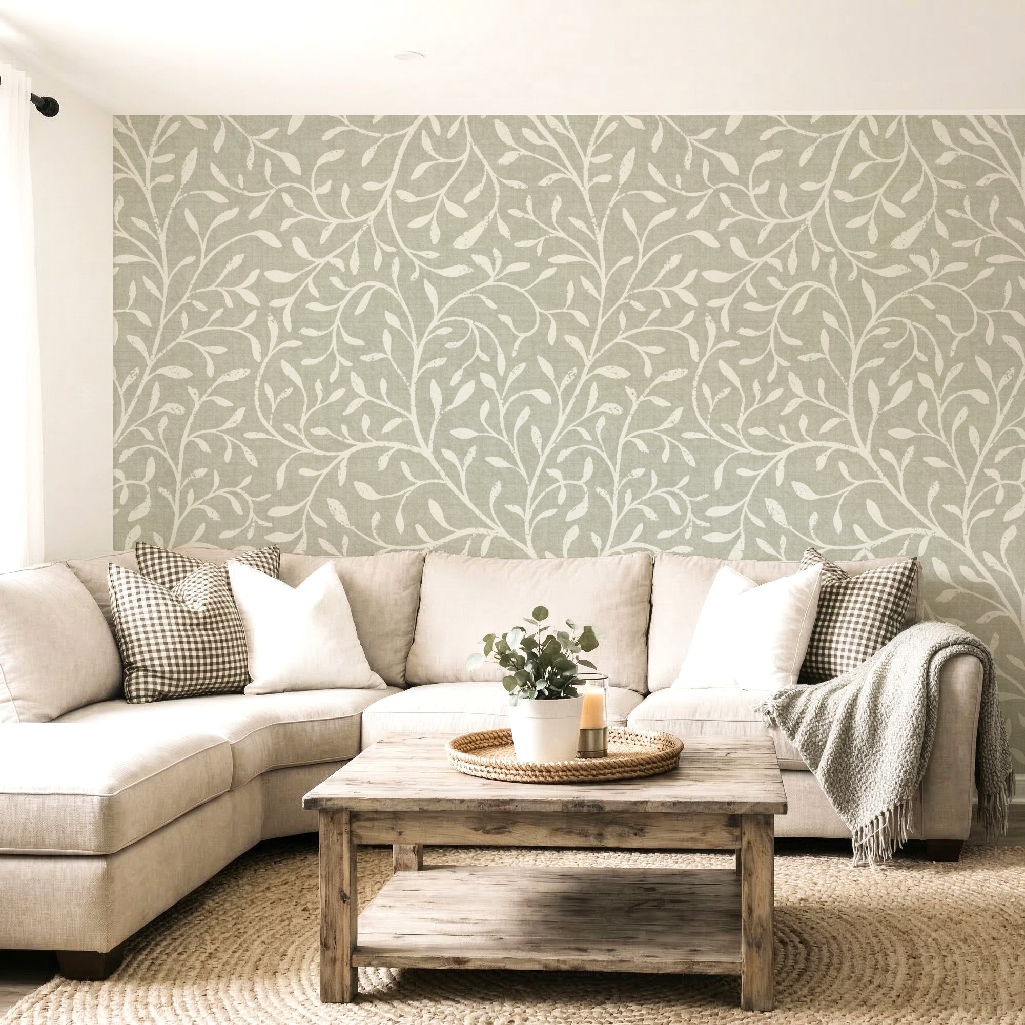 Bright Living room with green a green botanical vine wallpaper pattern on the wall with a beige corner soffa and a wooden table