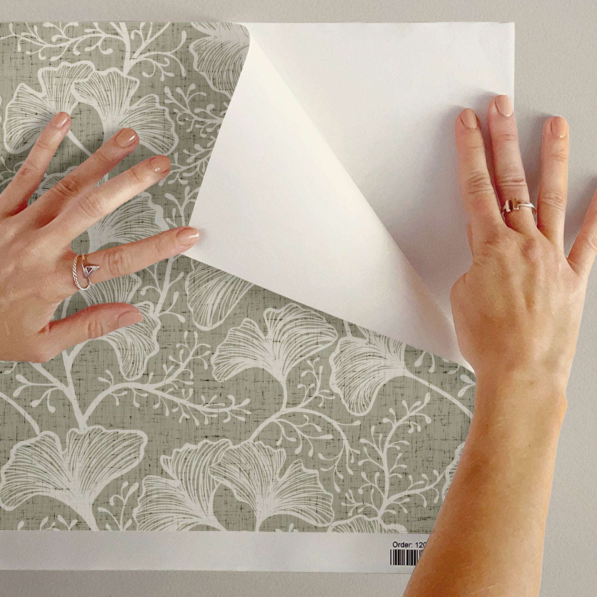 Ginkgo leaf wallpaper sheet in pale grey-green with white botanical repeat pattern.