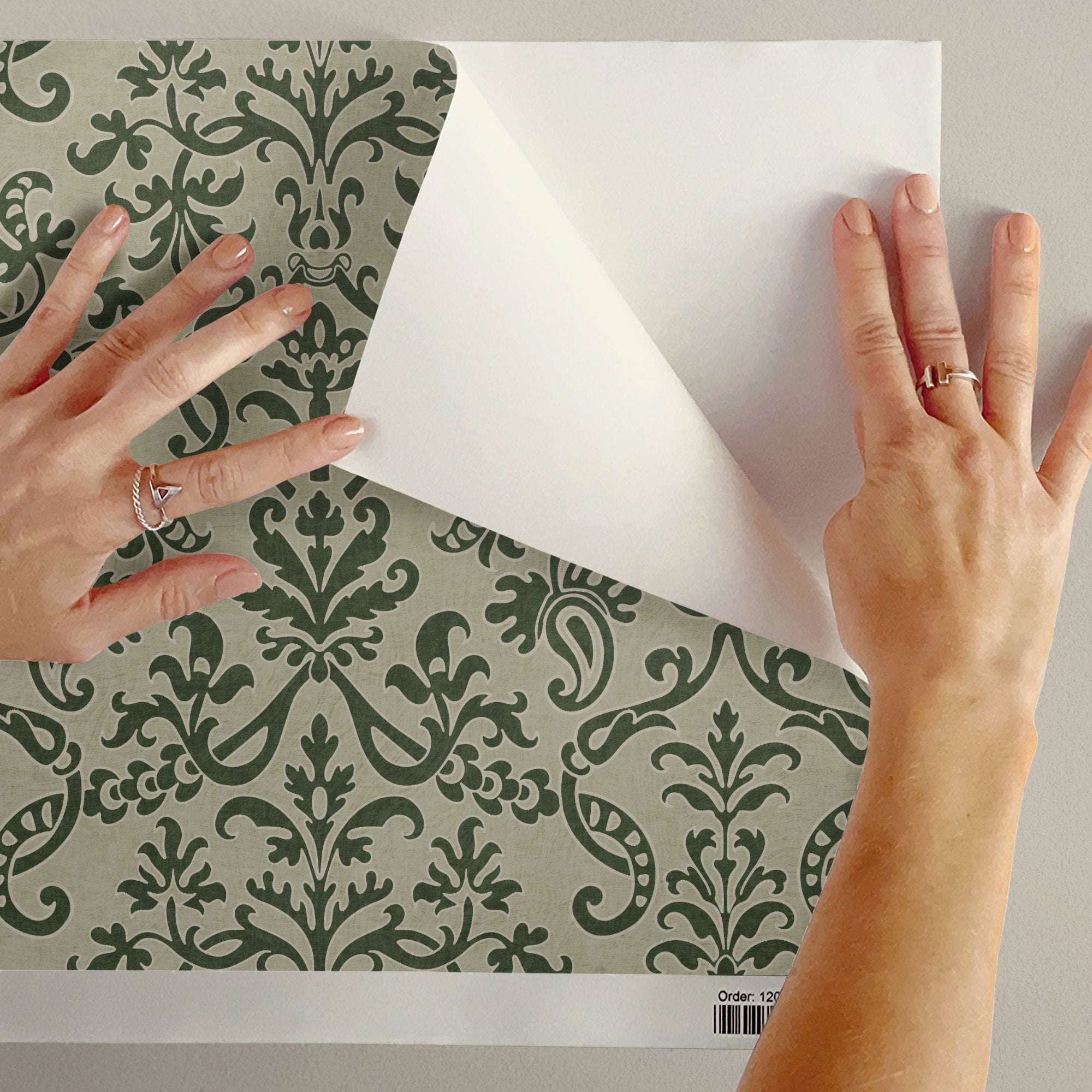Floral damask wallpaper with green damask pattern on one side, white backing visible