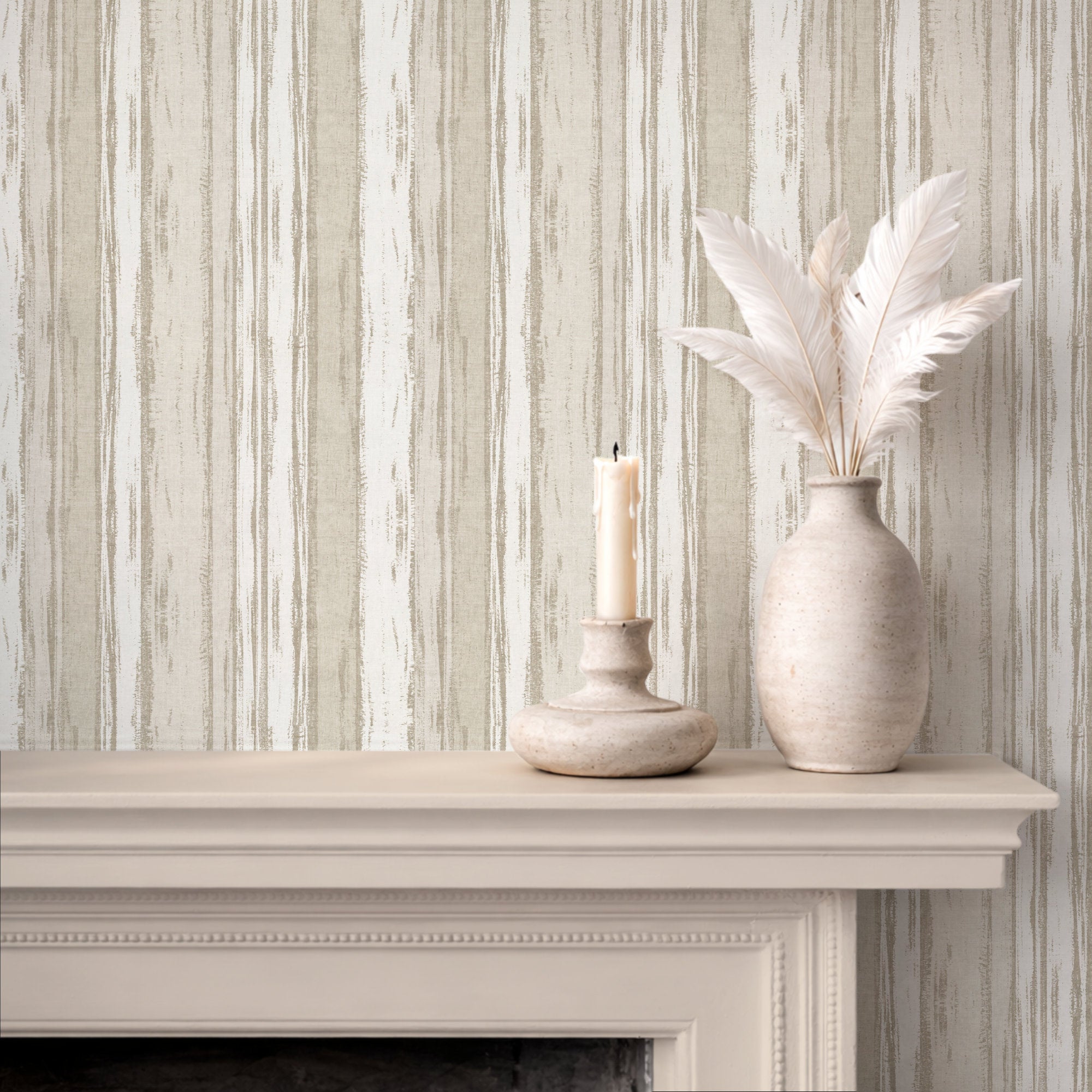Abstract stripe wallpaper displayed above a mantel with a candle and decorative vase with feathers.