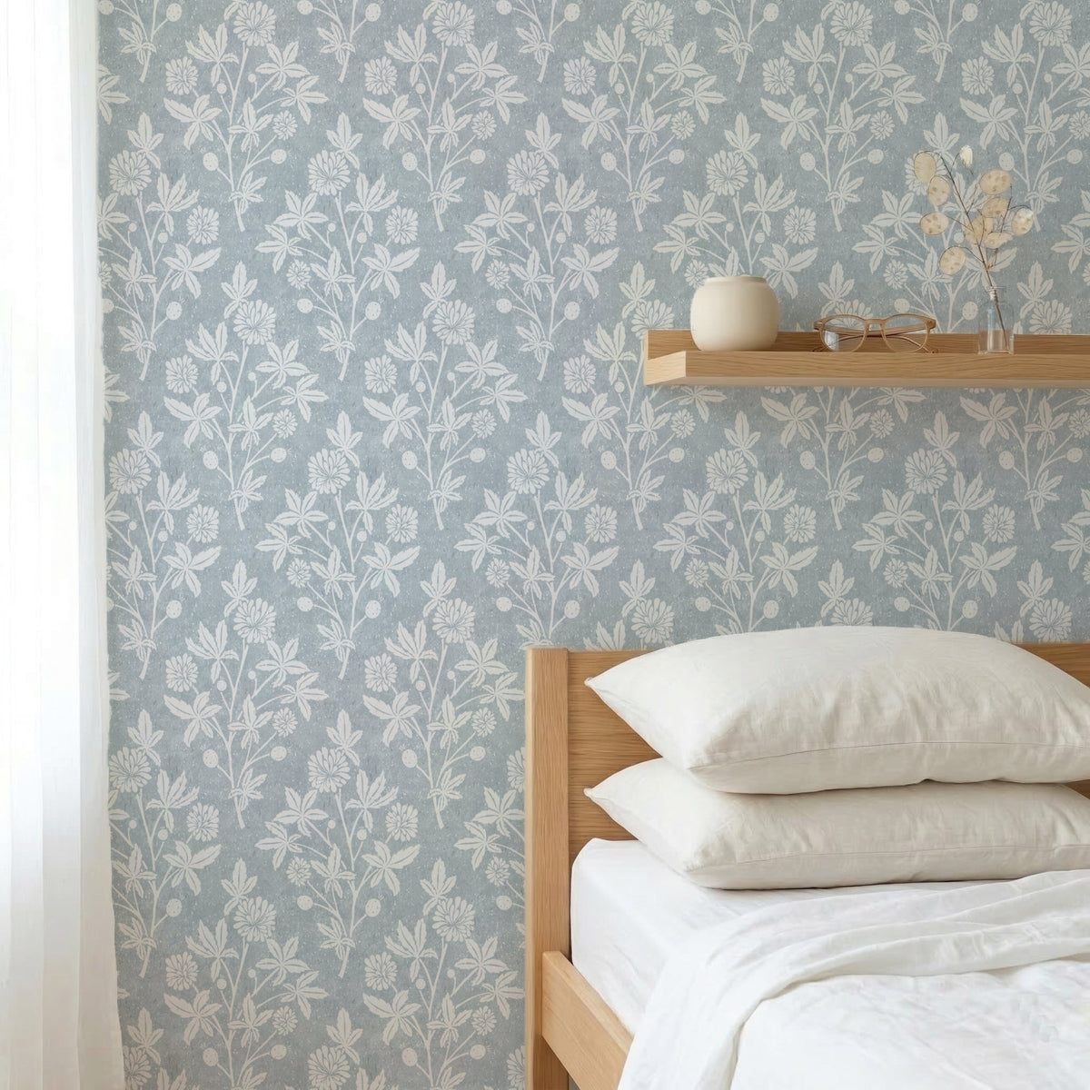 Bedroom with light blue block print floral wallpaper in a geometric diamond and wooden bed
