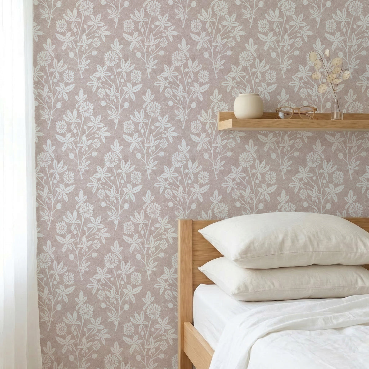 Bedroom with light dusty pink block print floral wallpaper in a geometric diamond and wooden bed