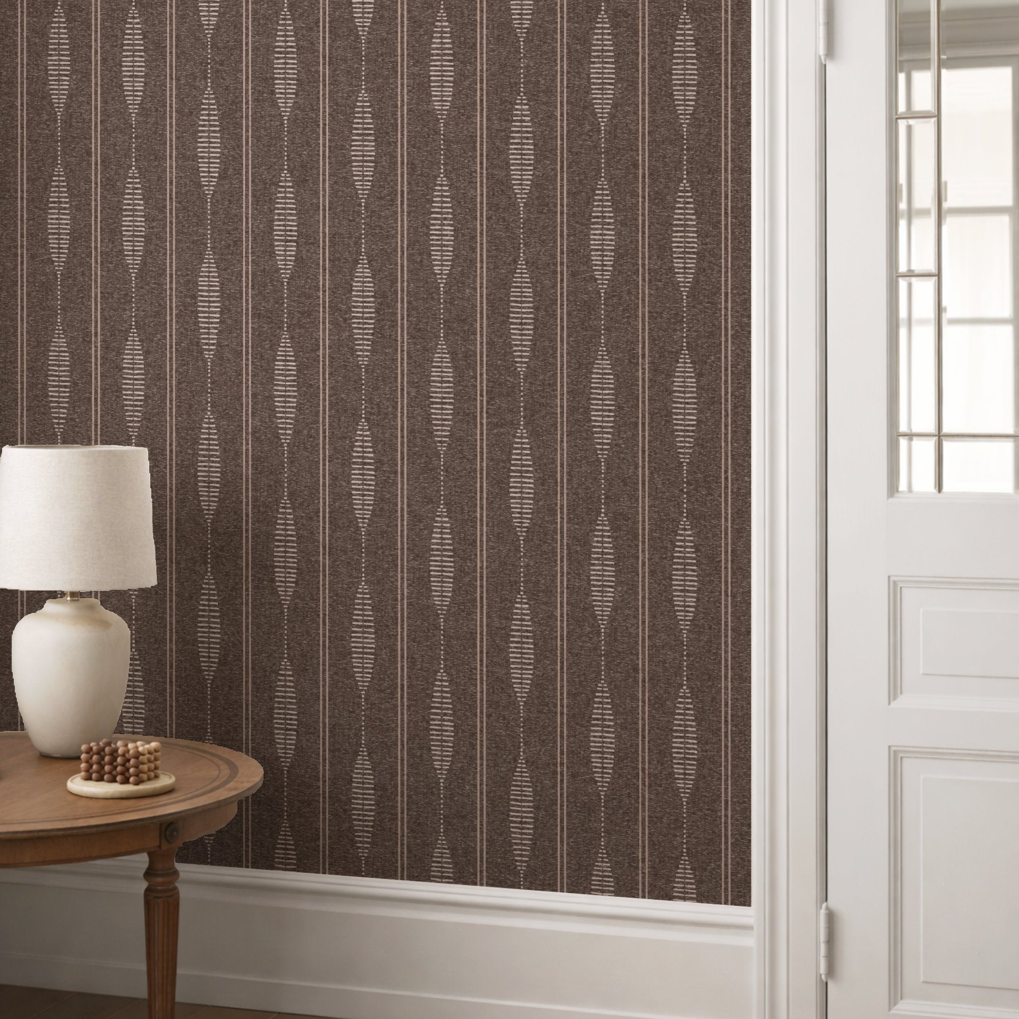 Brown linen stripe wallpaper in a hallway with a console table and lamp