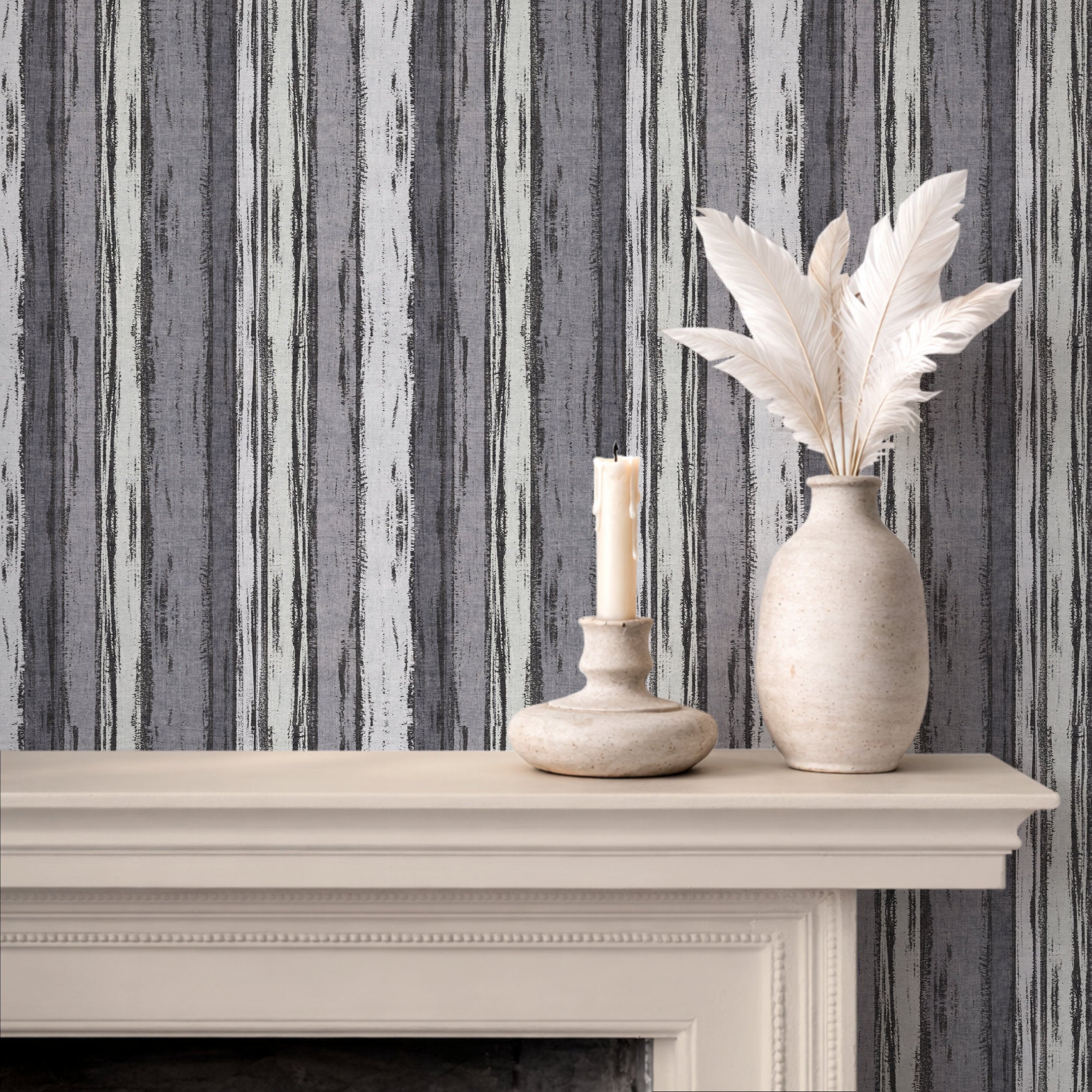 Abstract stripe wallpaper in textured brushstroke design displayed above mantel with decorative vase and candle.