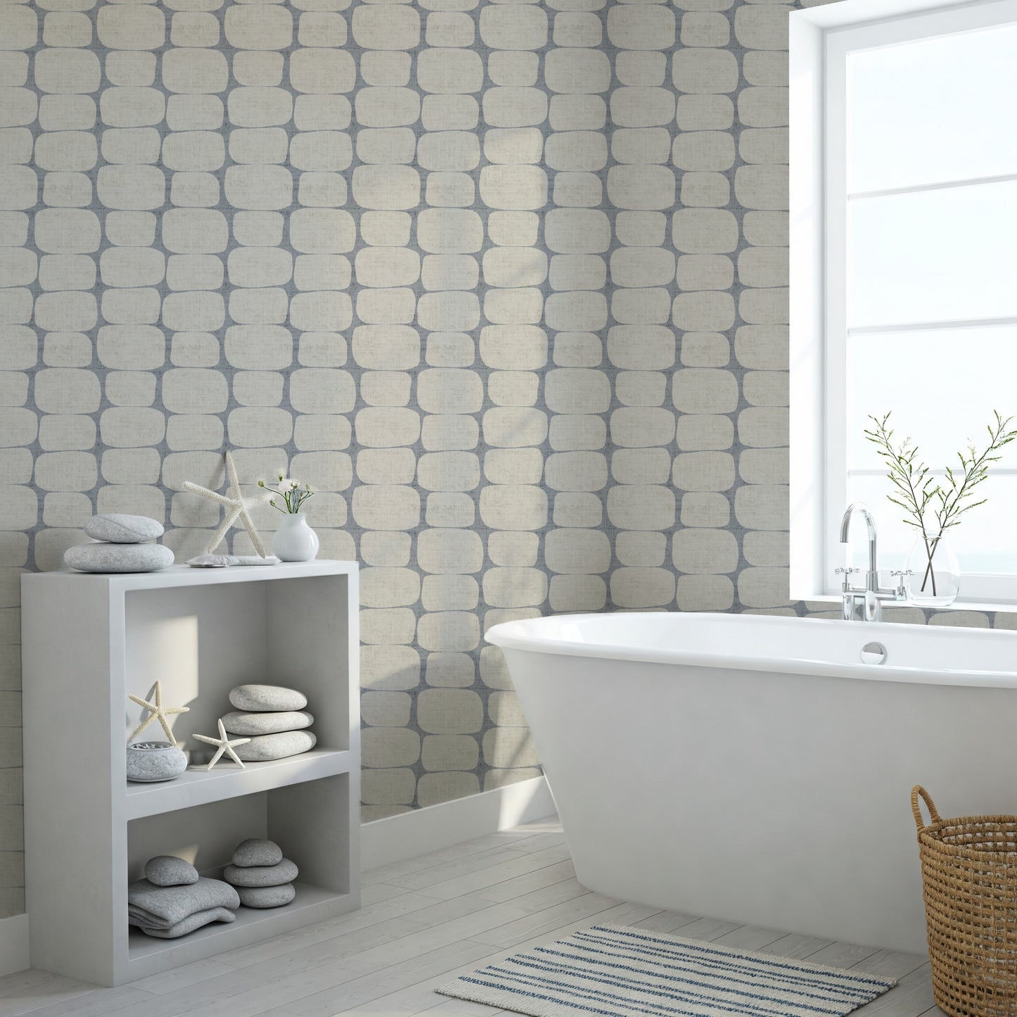 Modern bathroom with freestanding bathtub, geometric wallpapered wall, and decorative elements.