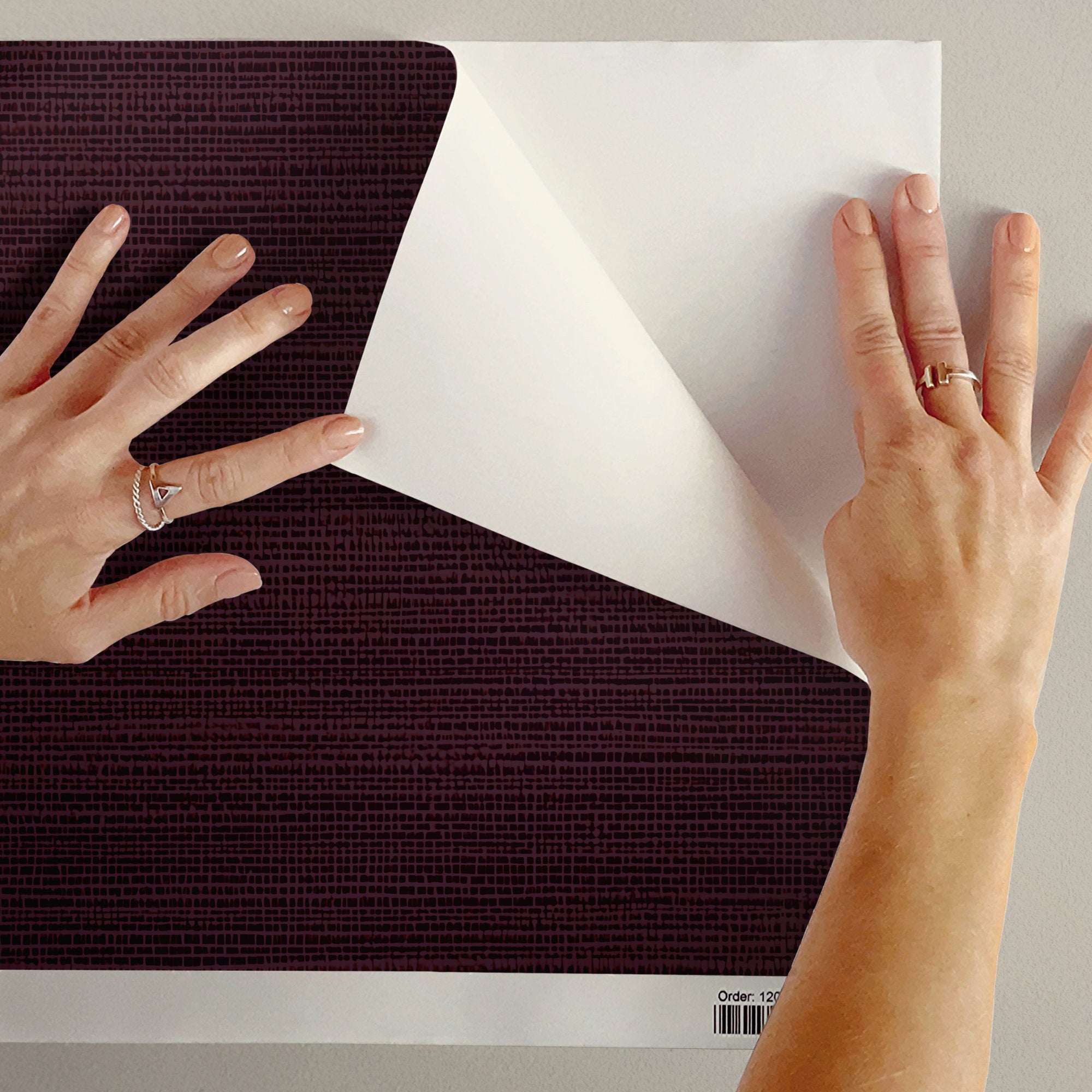 Faux grasscloth wallpaper sample sheet with woven texture, solid color backing