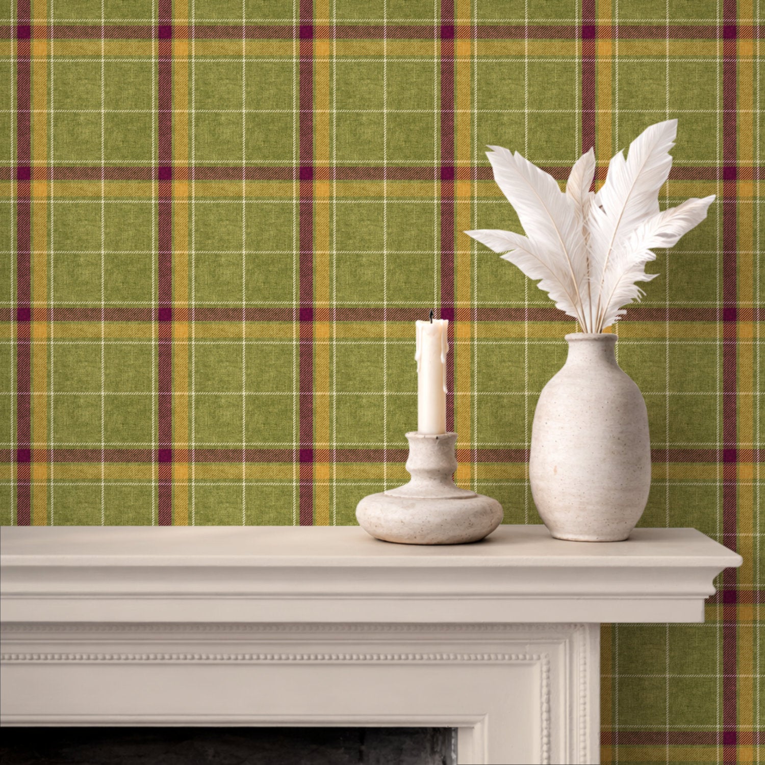 Green, yellow and plum heritage plaid wallpaper displayed behind a white mantel with a candle holder and a vase of white feathers.
