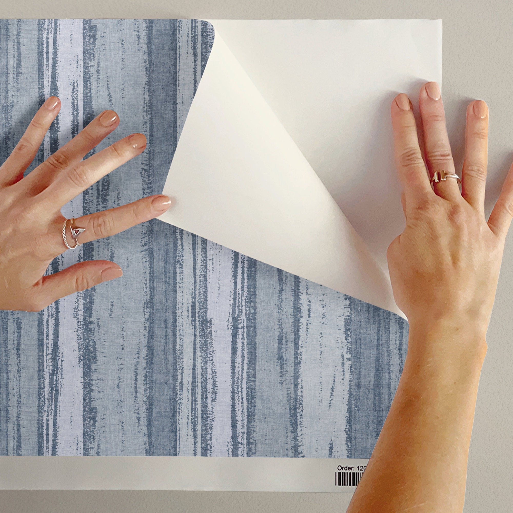 Abstract stripe wallpaper being unrolled to showcase textured brushstroke design.