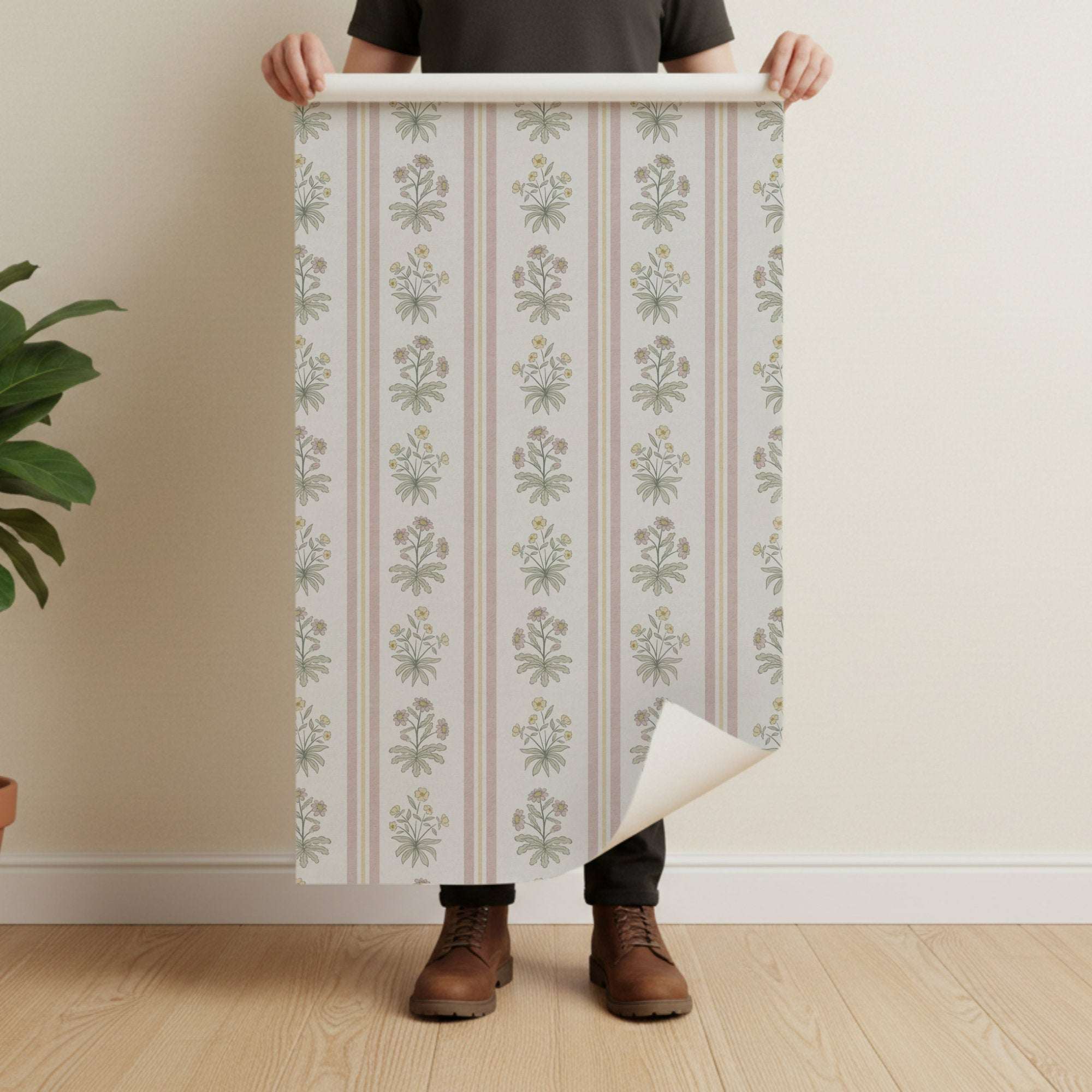 Floral stripe wallpaper with cottage flowers on pale background and vertical pink stripes, roll shown