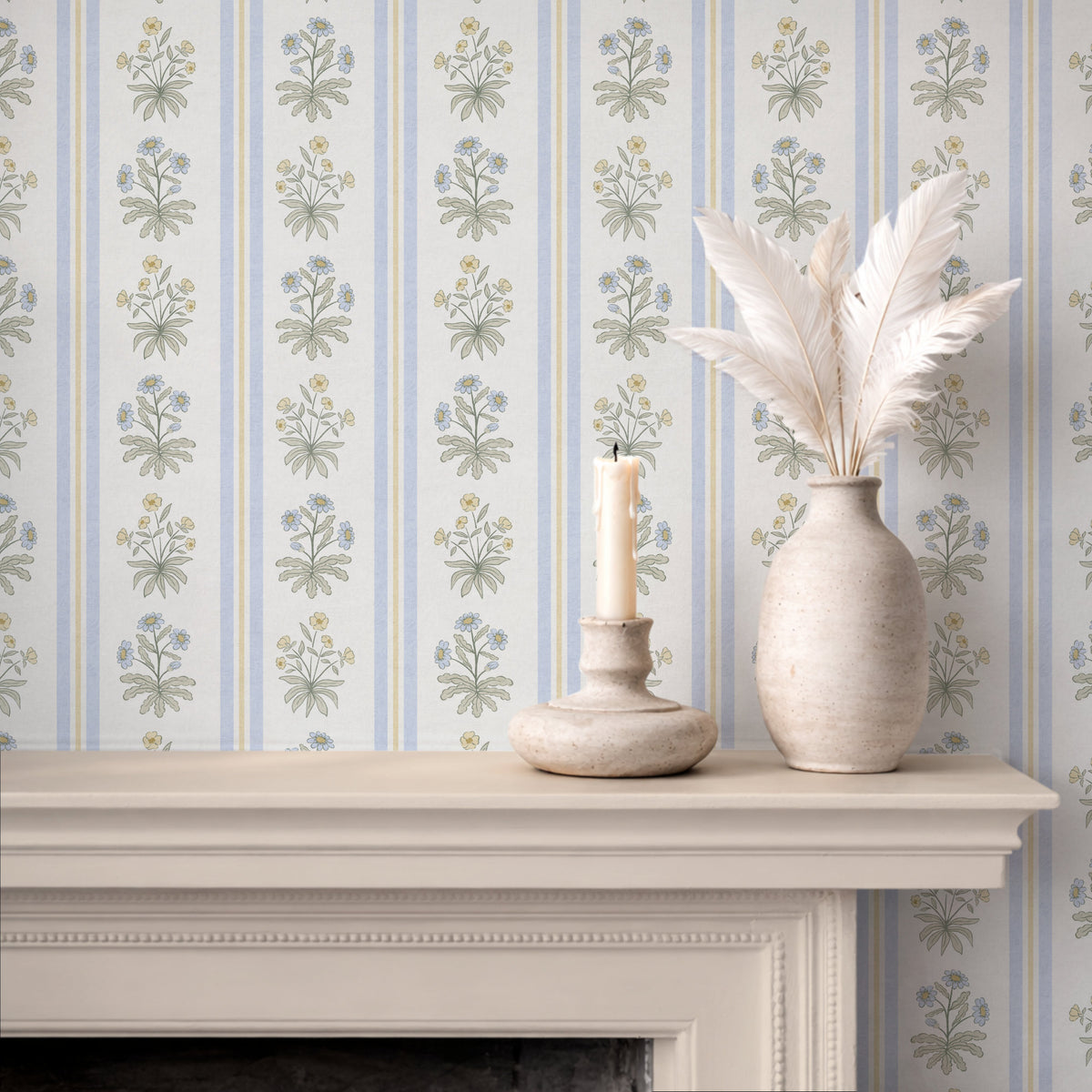 Blue floral stripe wallpaper above fireplace with candle and ceramic vase