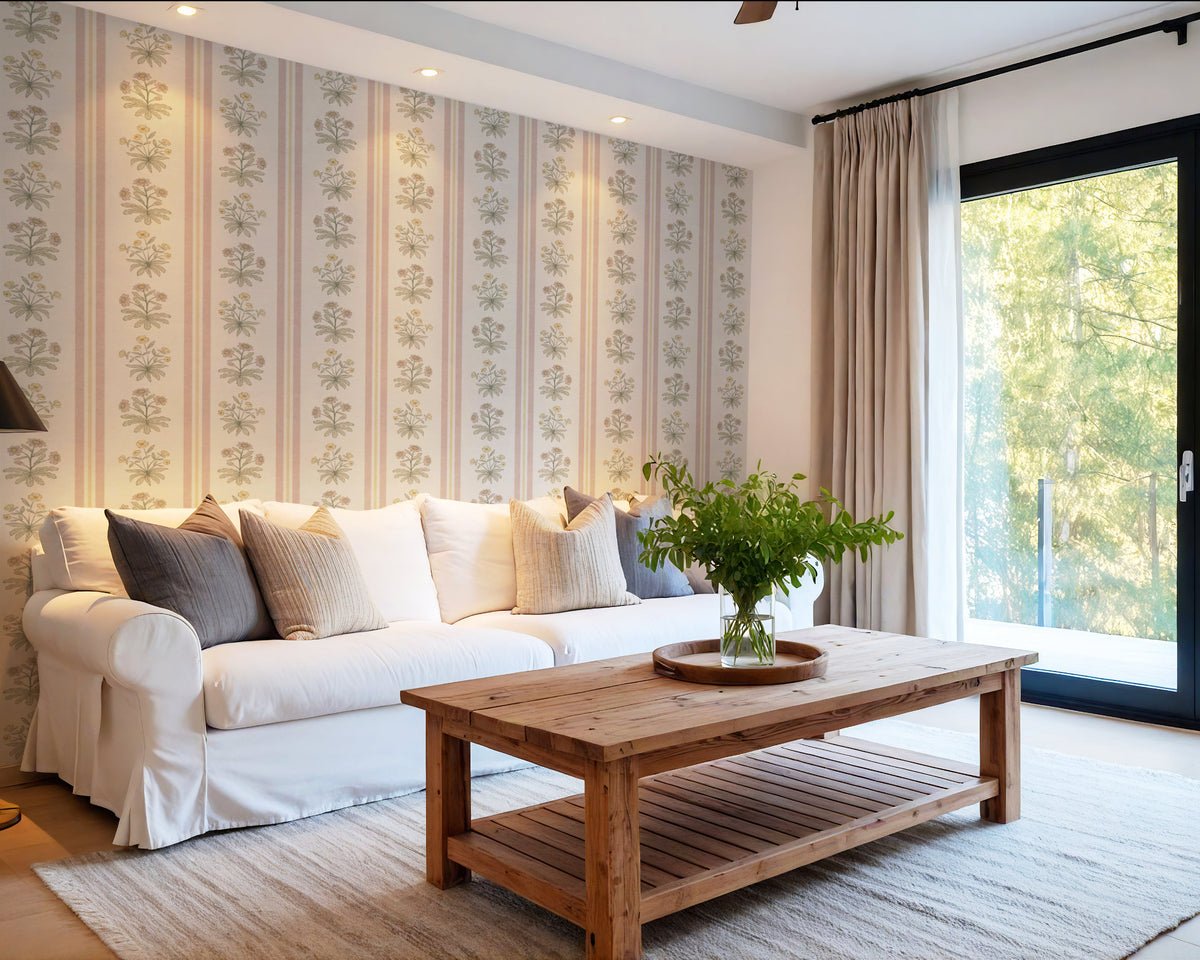 Pink and yellow floral stripe wallpaper in living room with white sofa and wood coffee table
