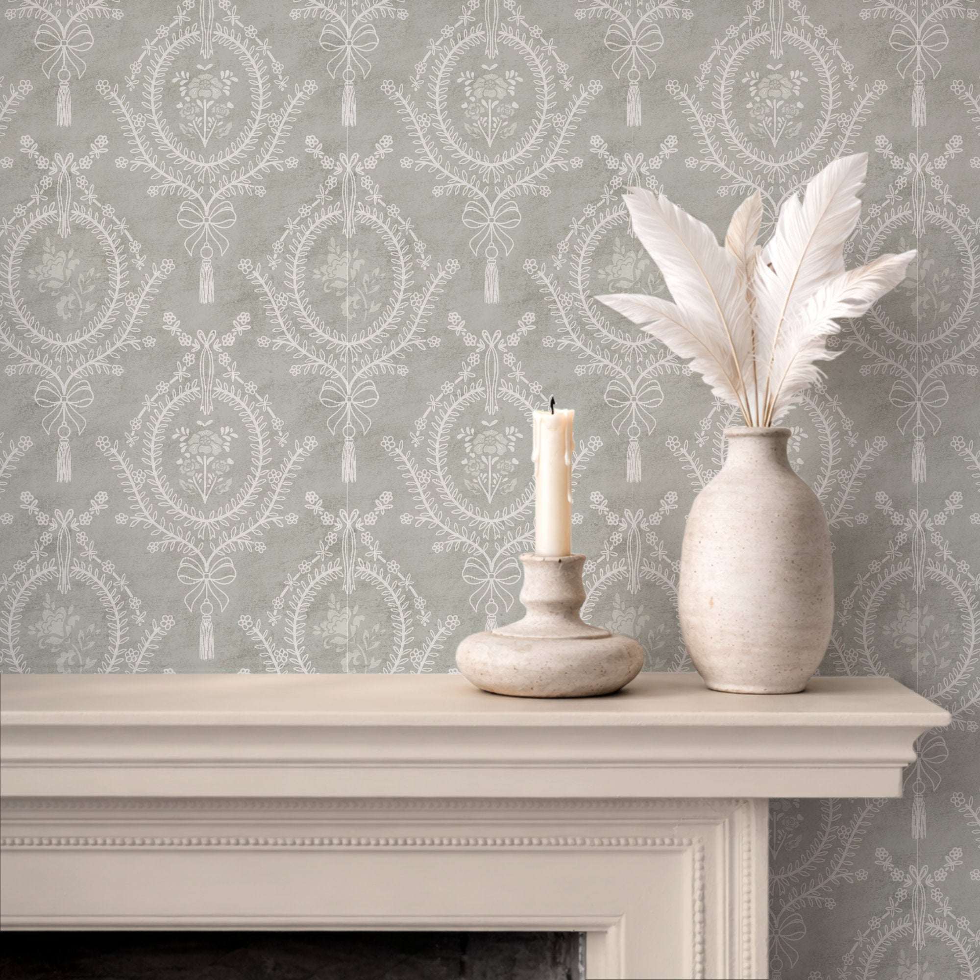 Gray floral wallpaper with repeating round medallions, bows, and tassels.