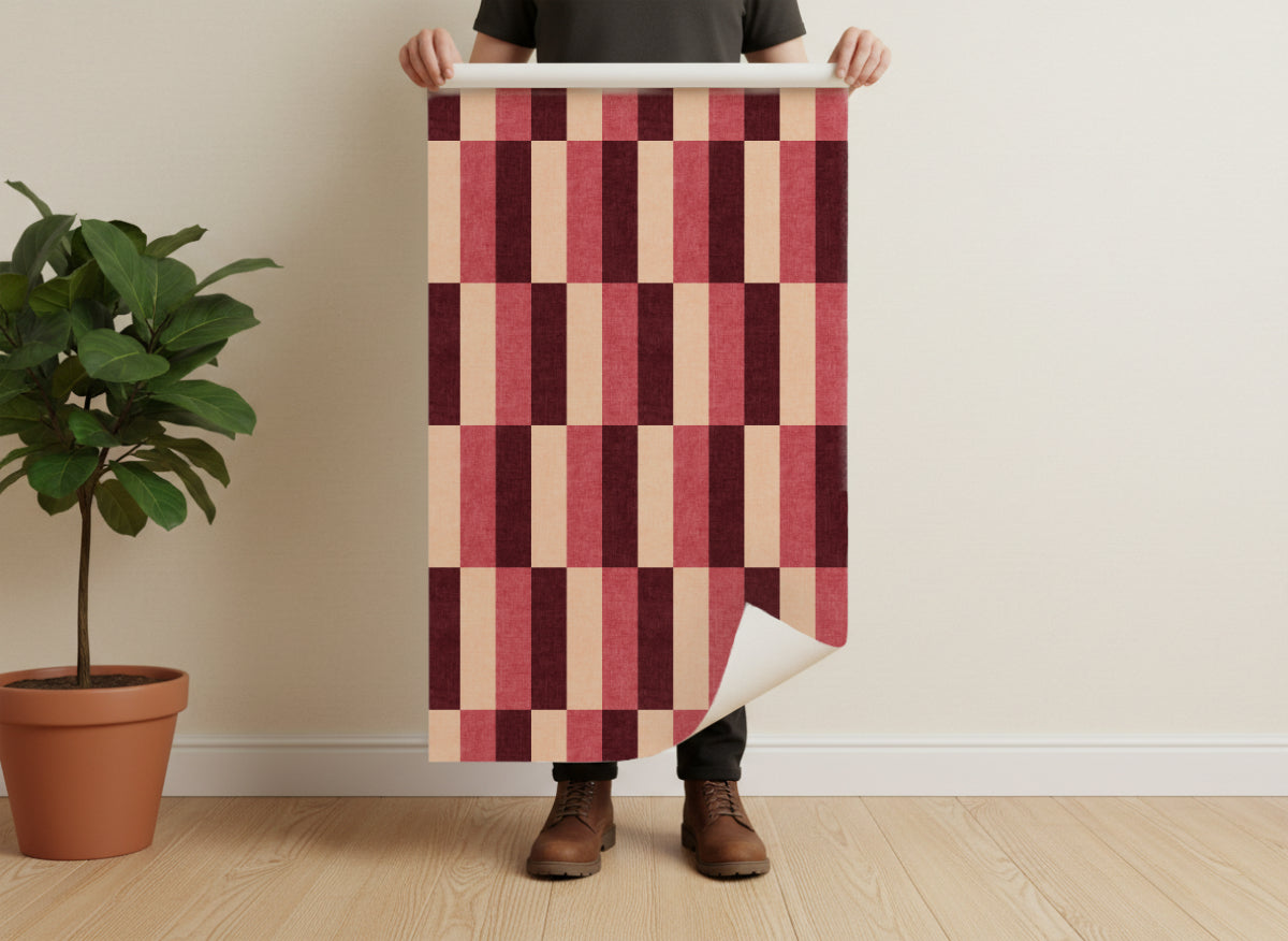 Wallpaper sample with burgundy and cream staggered block stripe pattern on roll