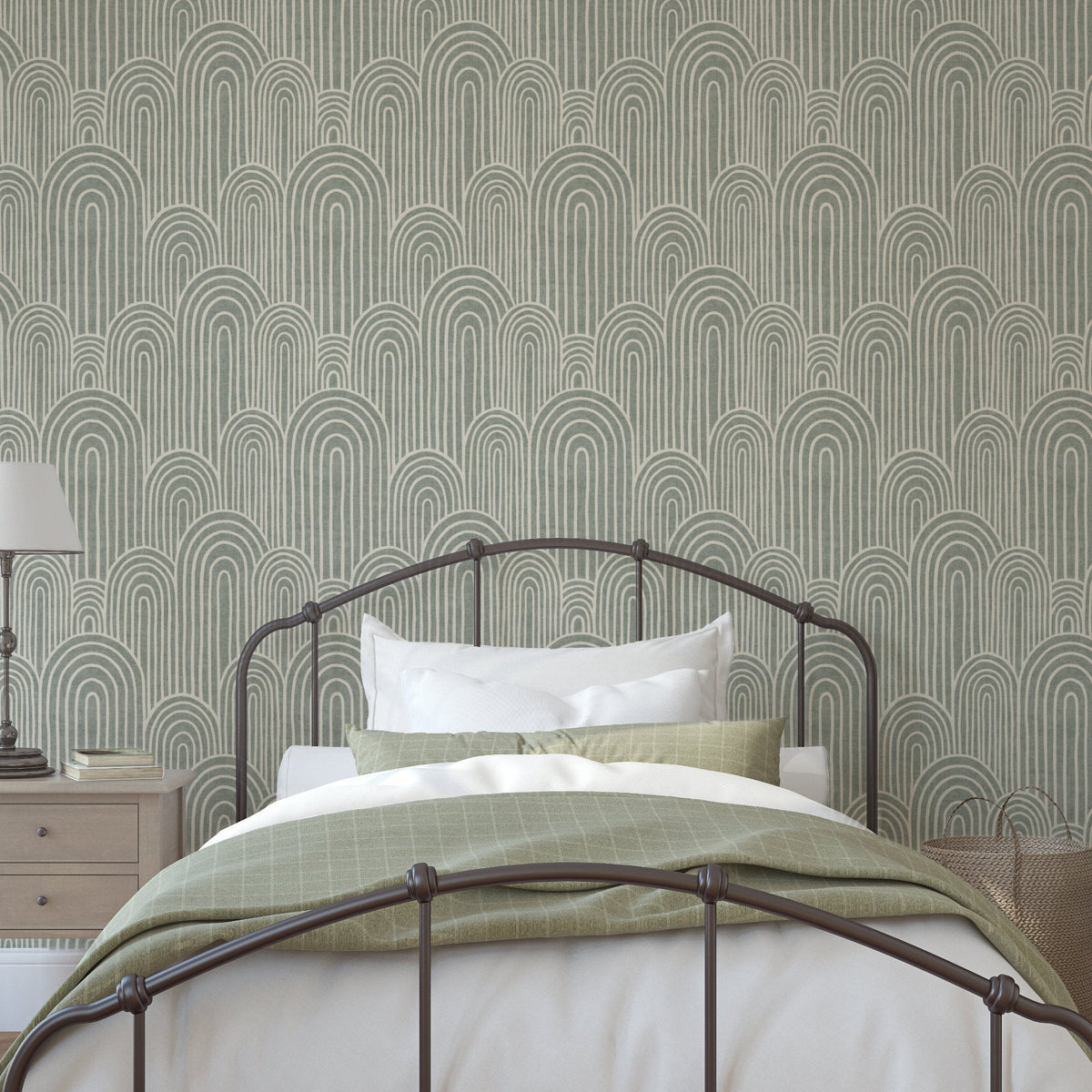 Sage green Scandinavian arches wallpaper behind a metal bed in a modern bedroom with white bedding