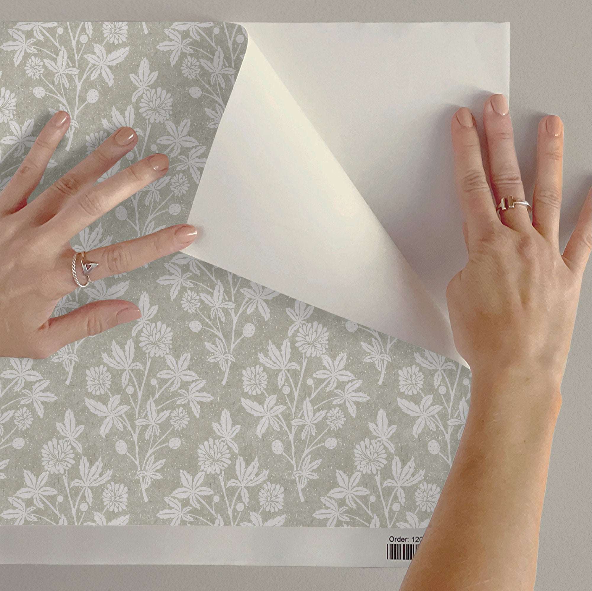 Botanical floral wallpaper roll with white blossoms and berries on light gray-green ground