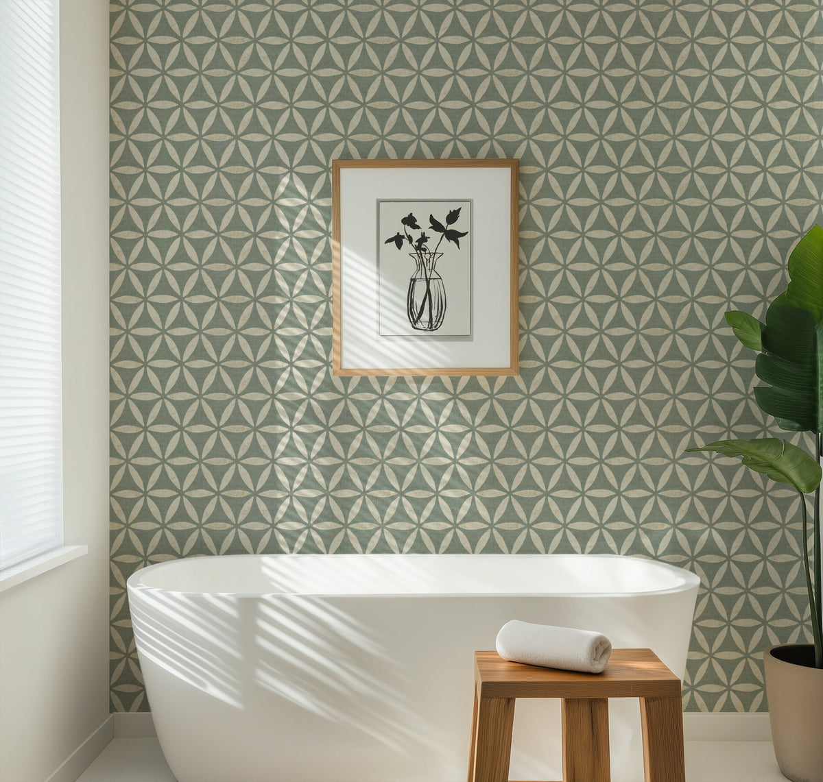 Teal geometric wallpaper with flower of life pattern in a modern bathroom with a white bathtub and framed art