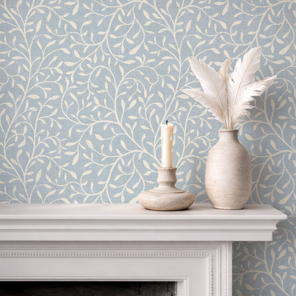 Botanical print wallpaper in soft blue on fireplace mantel with white ceramic vases