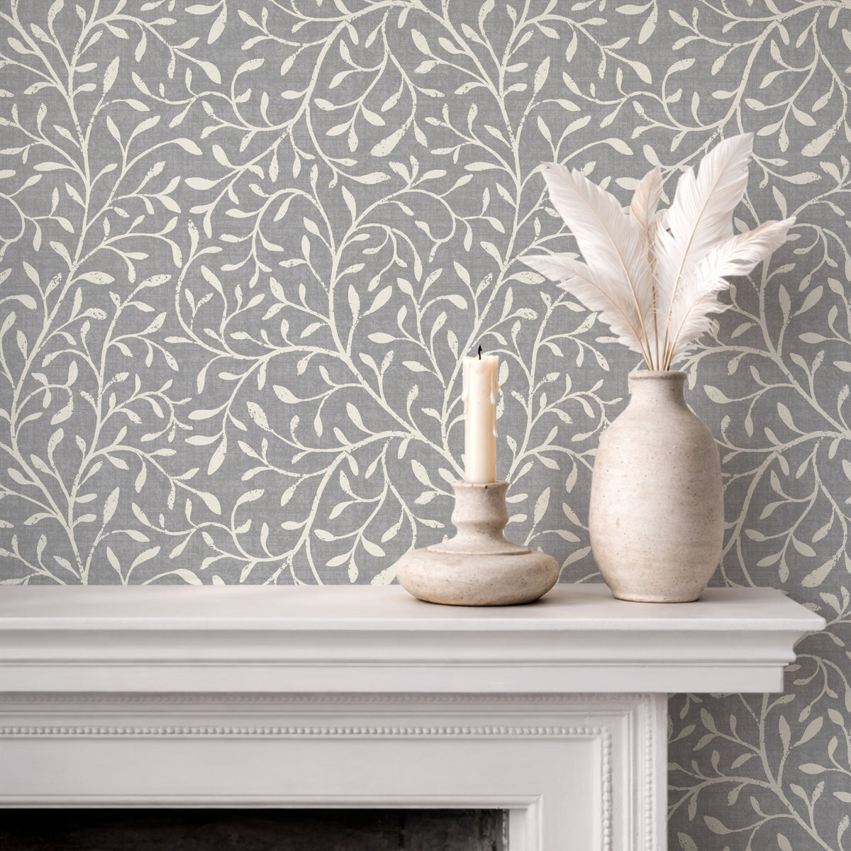 Botanical leaf silhouette wallpaper in pale neutral soft grey on fireplace mantel with white vases