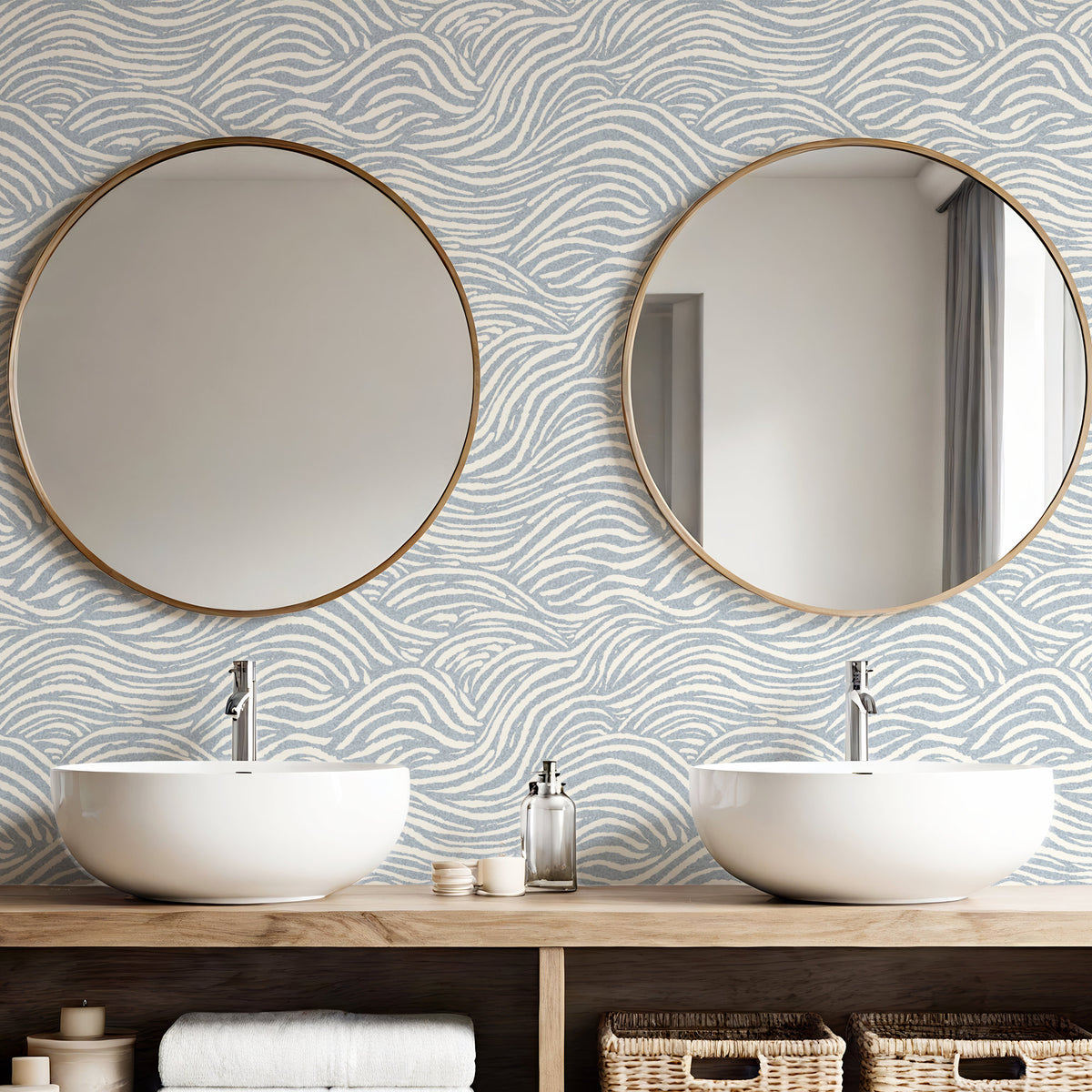 Blue coastal wallpaper in bathroom with round mirrors and white basins
