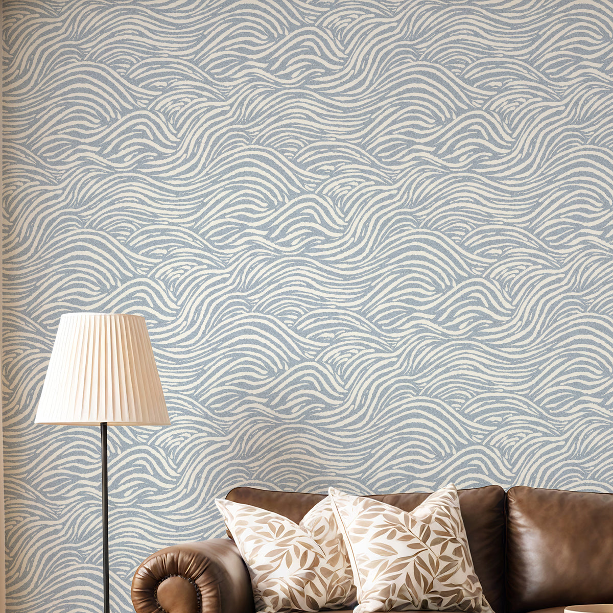 Coastal waves wallpaper in blue in living room with neutral sofa