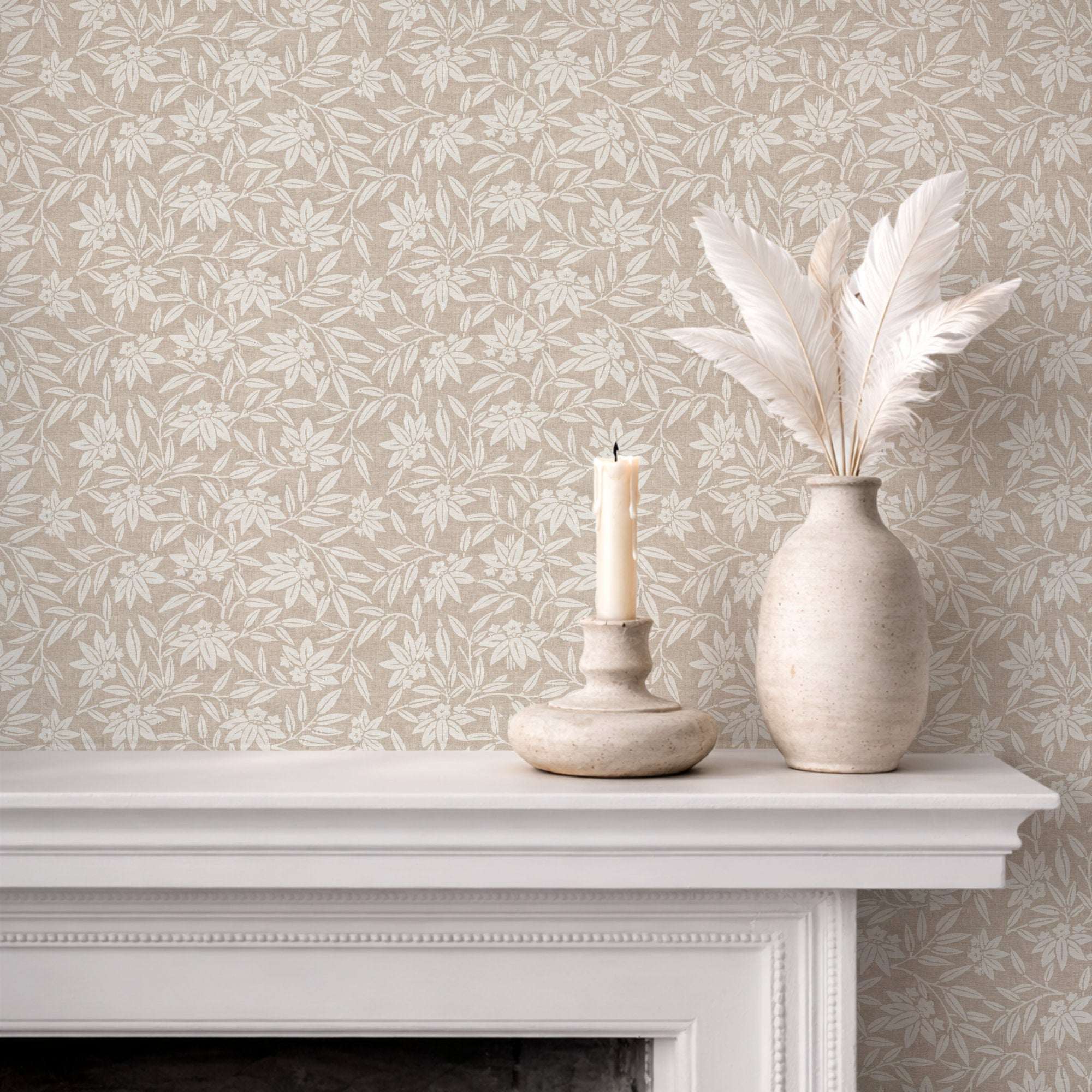 Botanical wallpaper on wall with repeating cream leaf sprigs and blossoms on warm beige