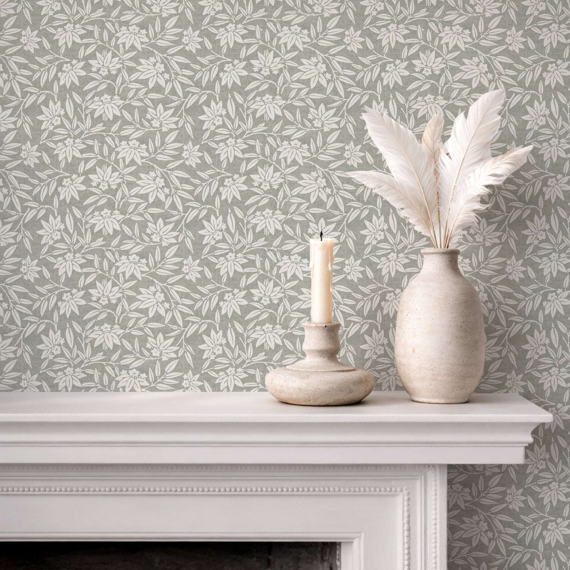 Botanical wallpaper on wall with repeating cream leaf sprigs and blossoms on gray-green