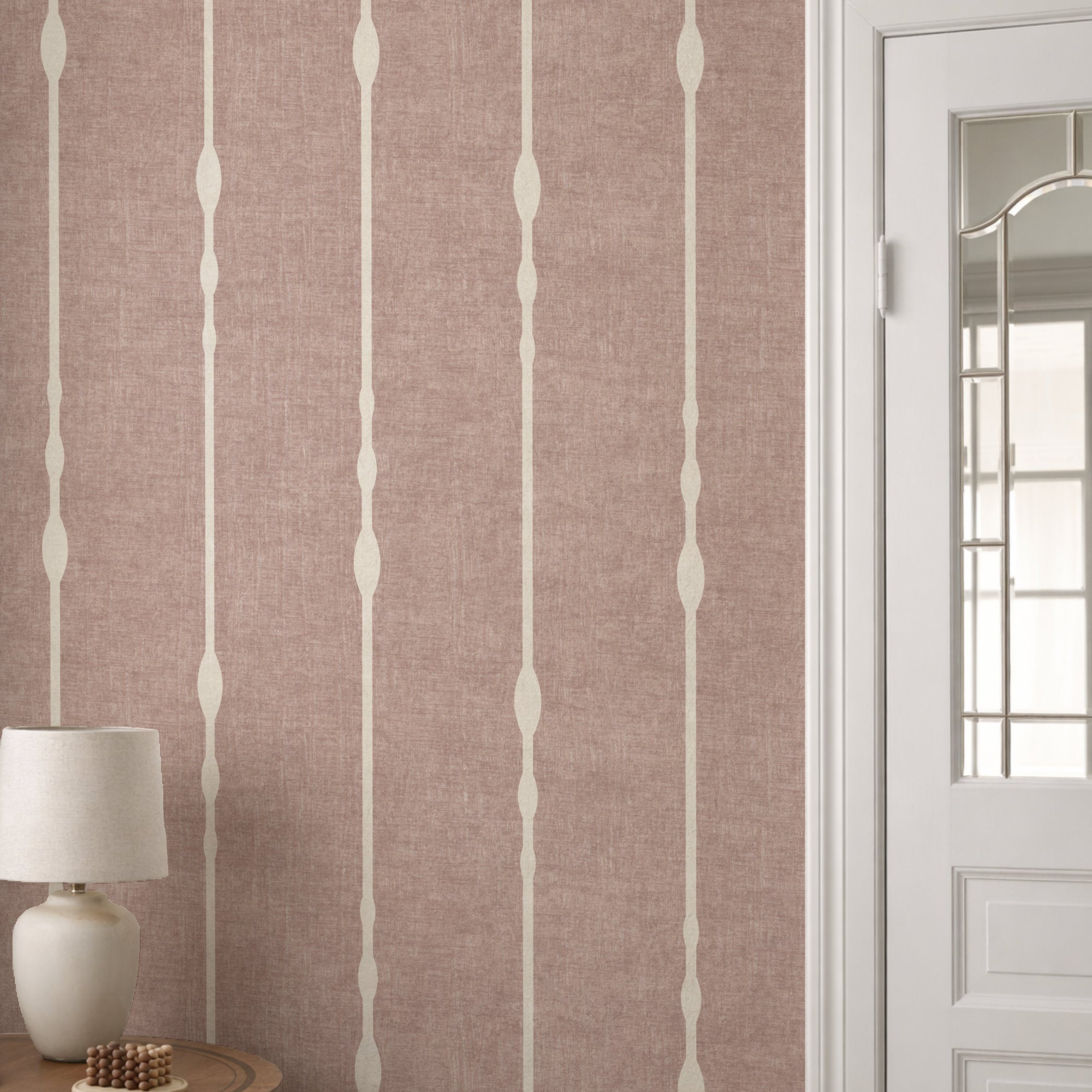 Vertical striped wallpaper in Blush Pink in soft neutral room with white panelling