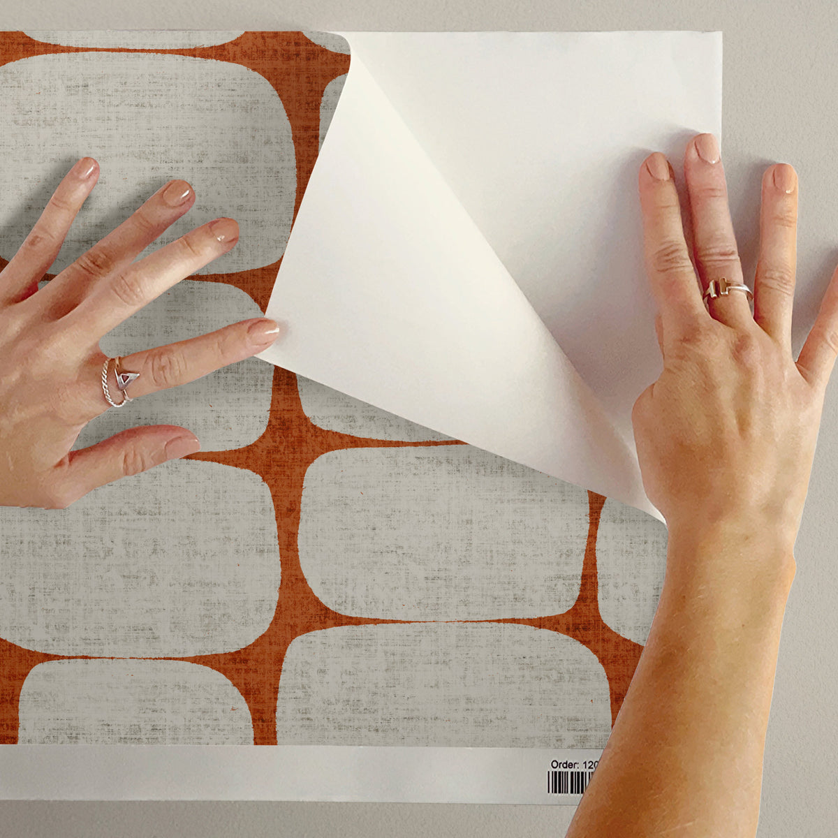 Peel and stick mid-century modern wallpaper sample showing Terracotta colourway