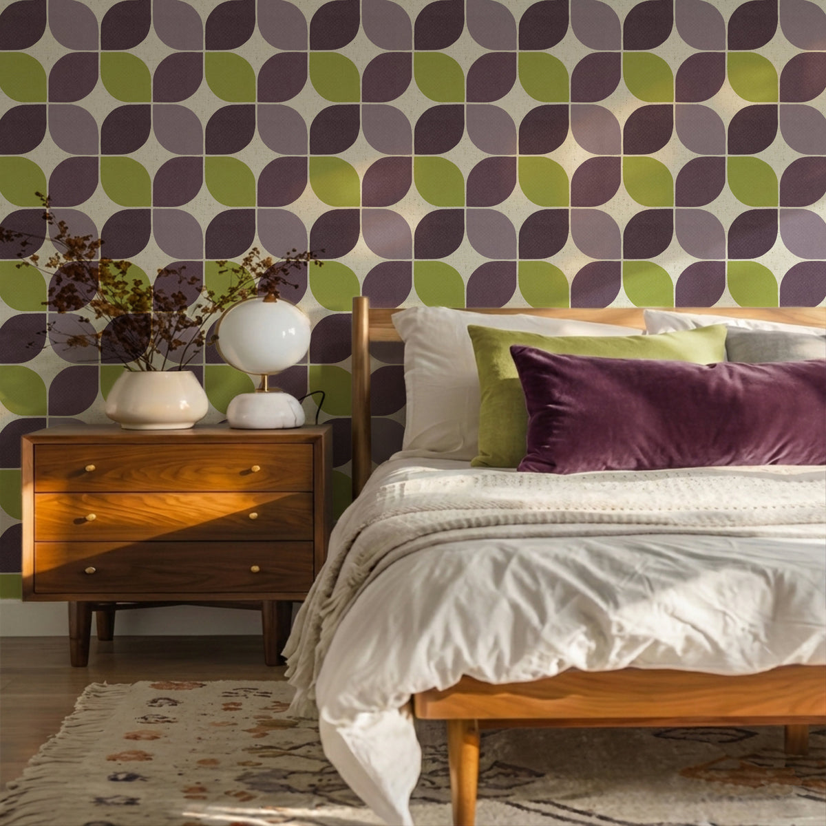 Mid century modern Bedroom in purple and green with geometric patterned wallpaper, wooden nightstand, and bed with pillows.