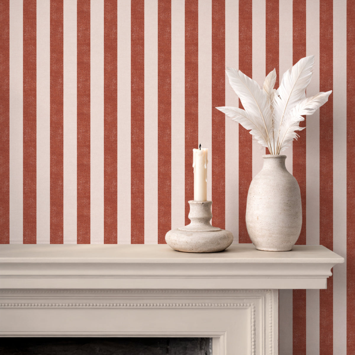 Bold wide stripe wallpaper in terracotta, styled with a fireplace mantel, earthy boho Mediterranean interior