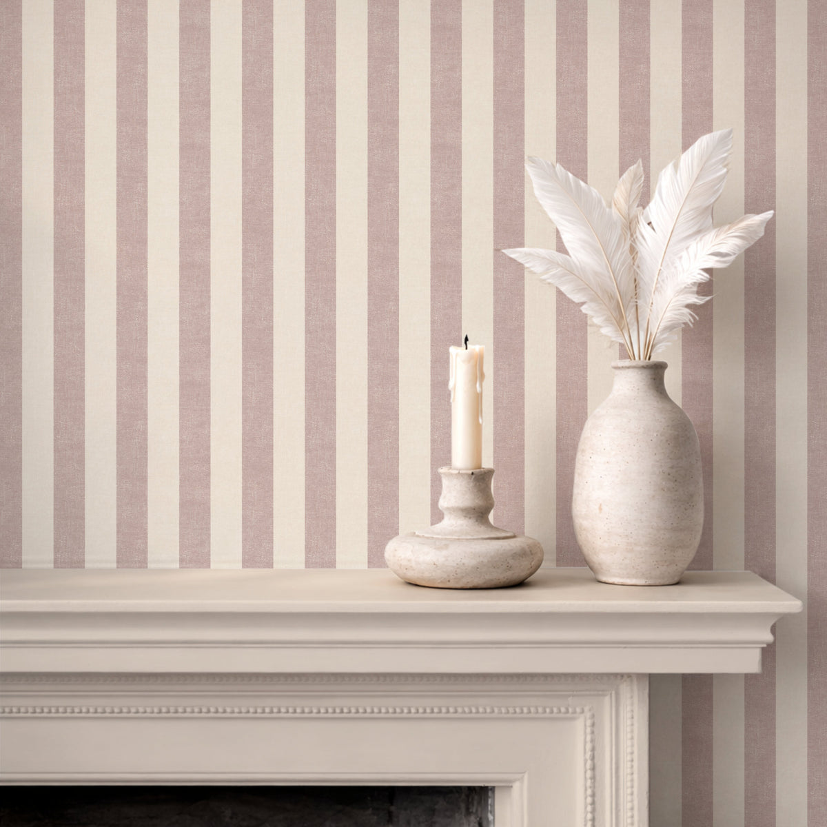 Textural stripe wallpaper in dusty pink, styled with a fireplace mantel, soft quiet luxury interior