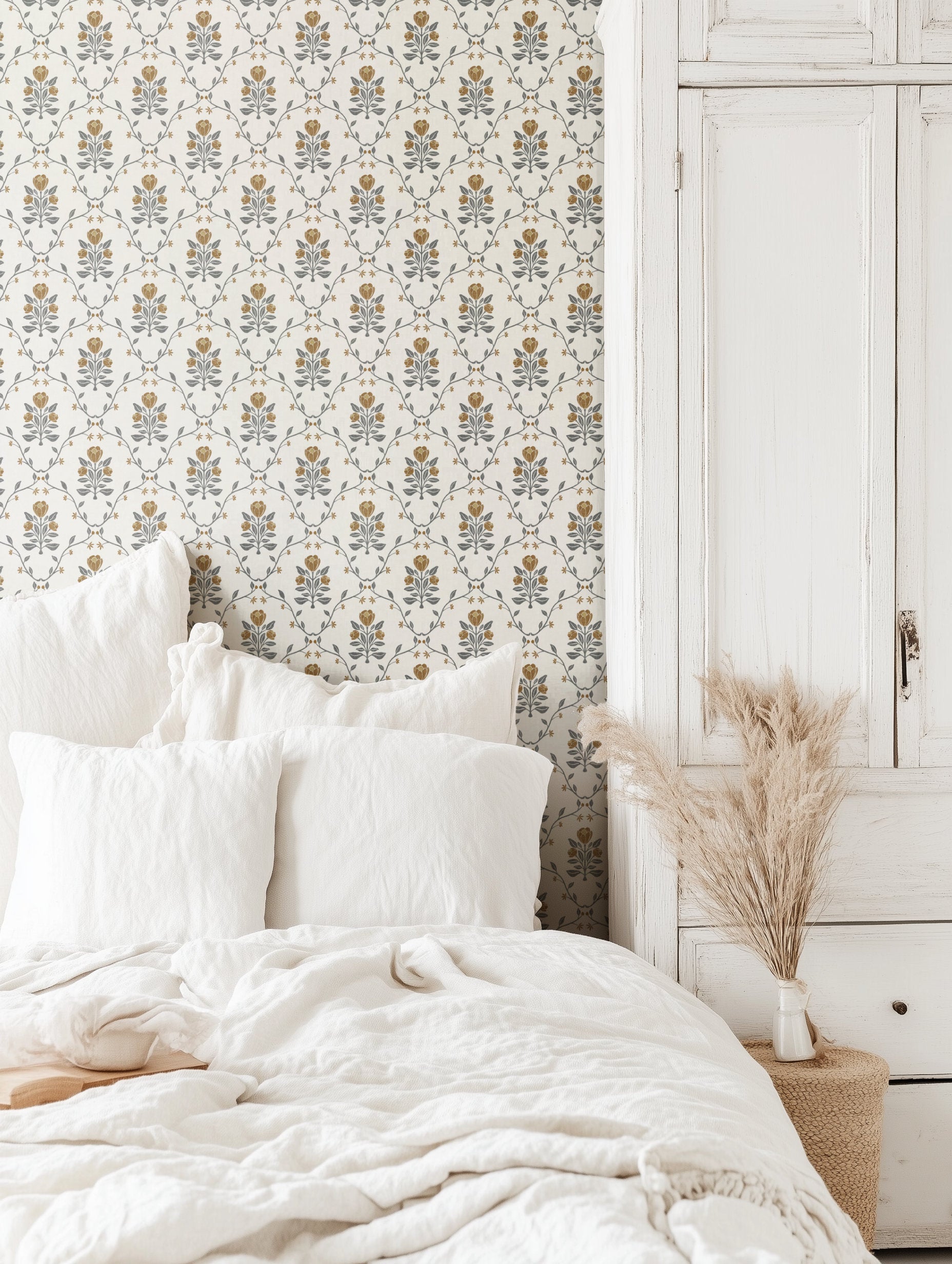 Ochre yellow tulip trellis wallpaper on a bedroom wall, hand-drawn tulips and dusty blue-grey foliage.