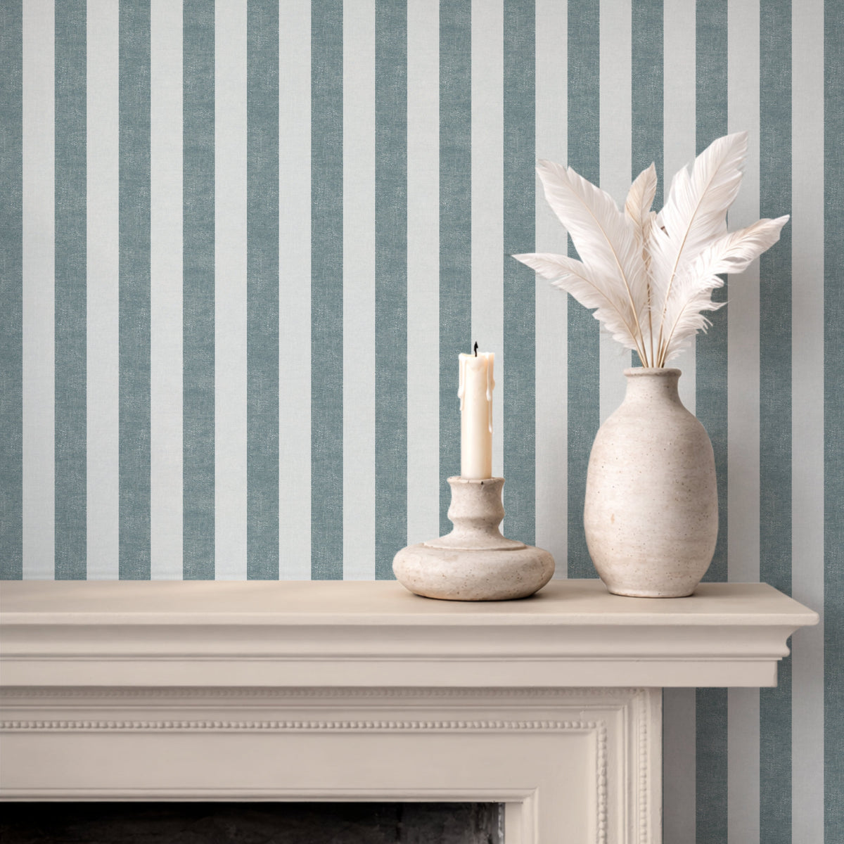 Bold vertical stripe wallpaper in denim blue, styled with a fireplace mantel, coastal and contemporary interior
