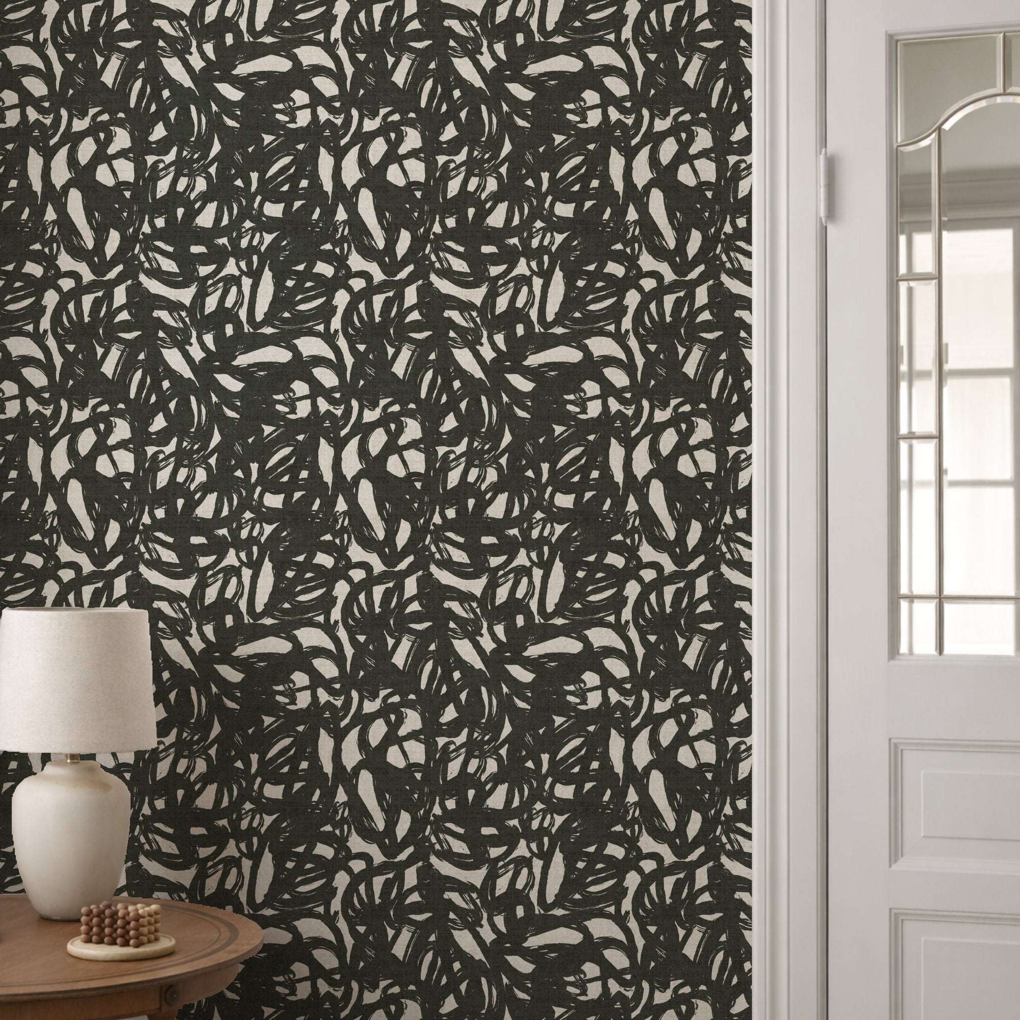 Black abstract brushstroke wallpaper with scattered light cream strokes repeat pattern