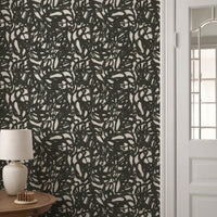 Black and white squiggle wallpaper roll showing bold abstract brushstroke pattern