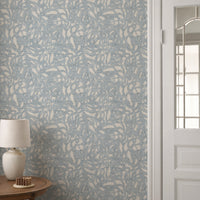 Brushstroke wallpaper roll in soft blue abstract pattern styled in a hallway