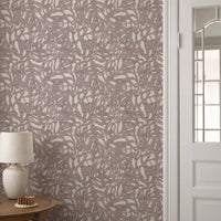Brushstroke wallpaper roll in muted mauve abstract pattern styled in a hallway