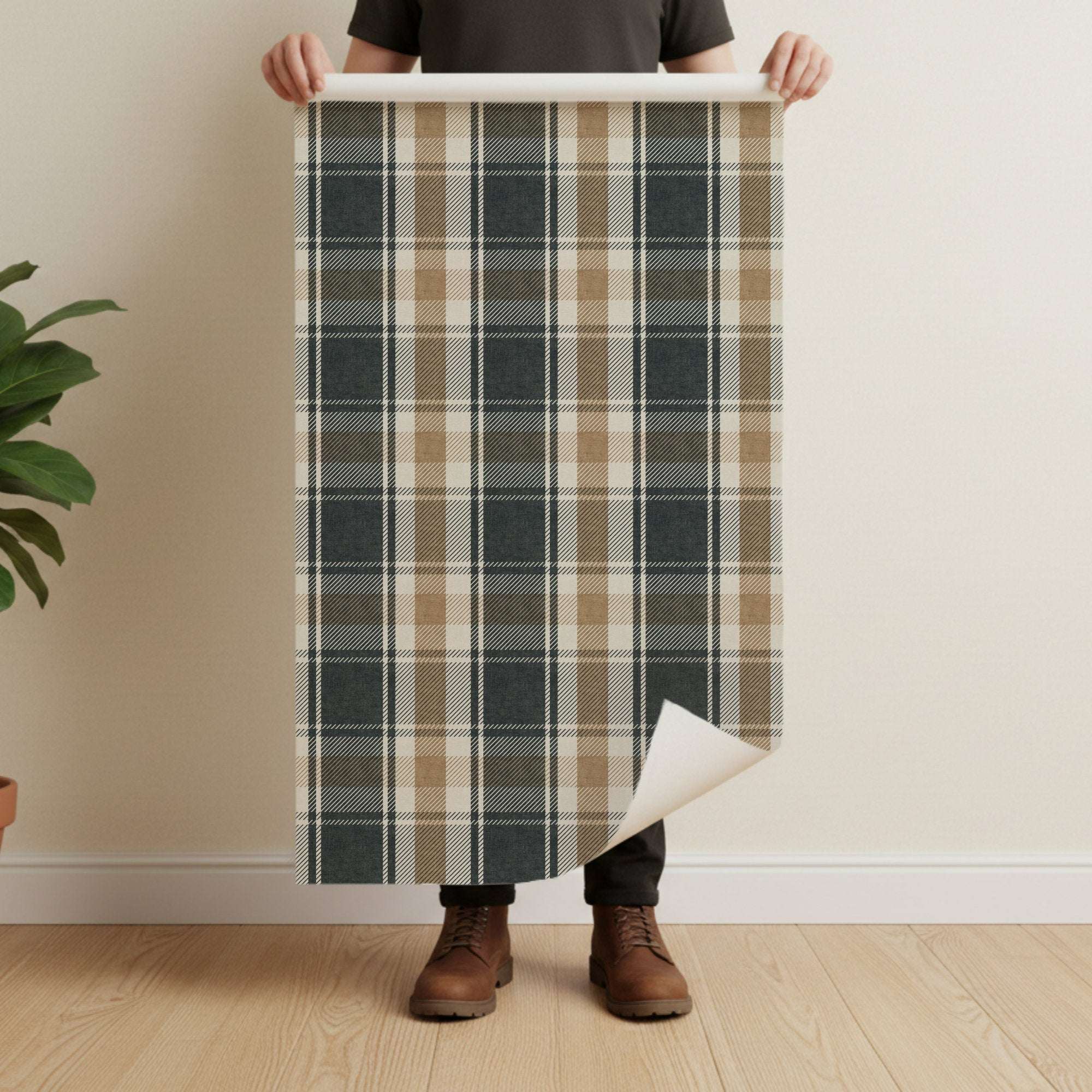 Unrolled tartan plaid wallpaper sheet with dark navy and tan grid lines on cream