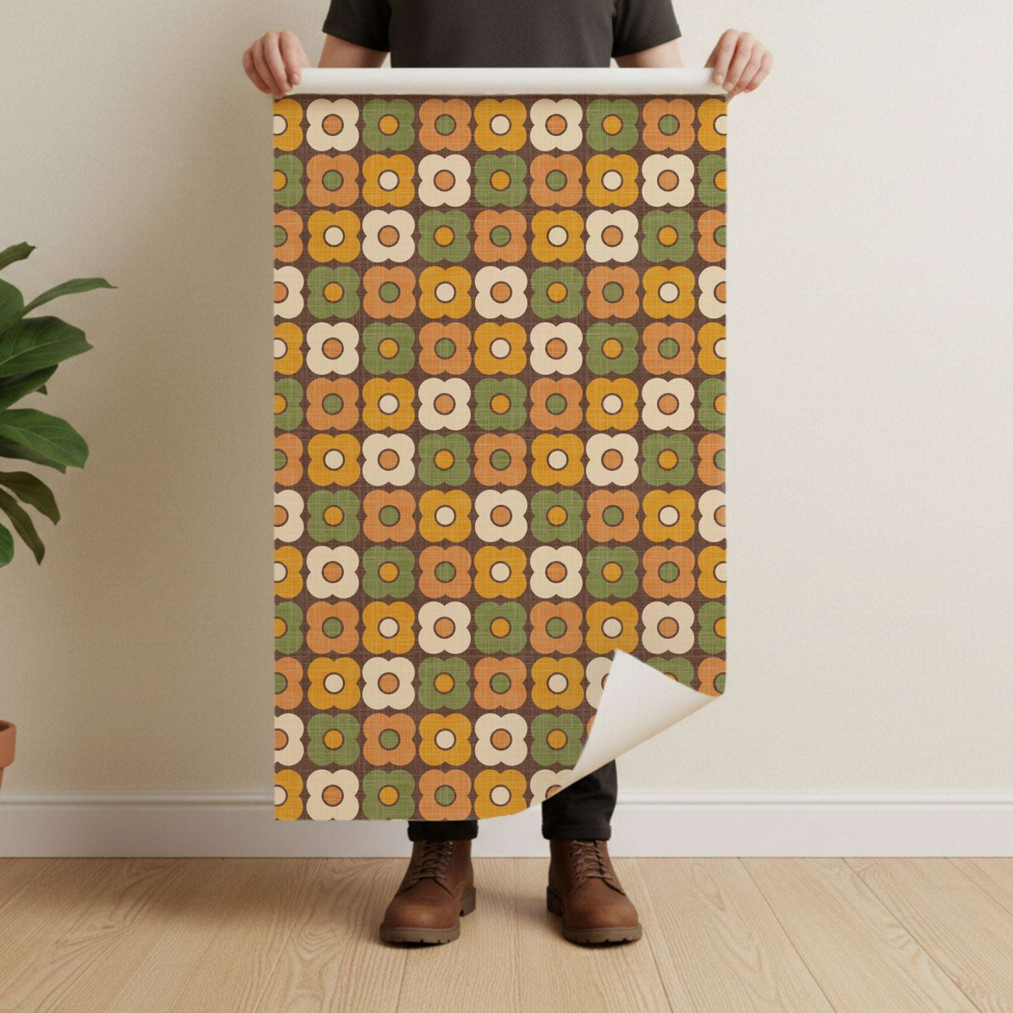 Retro daisy circle pattern wallpaper roll with brown ground and green orange white flower shapes.