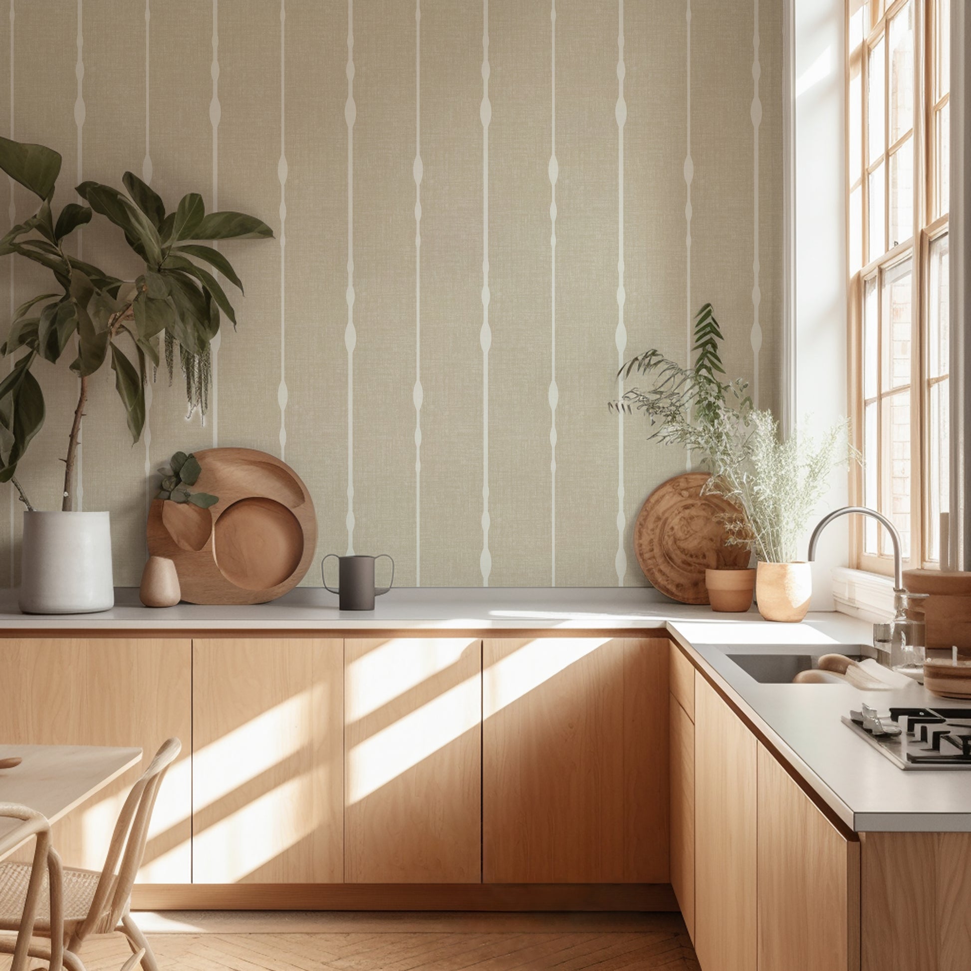 Beige vertical stripe wallpaper in a neutral kitchen with potted plants in a sunny room