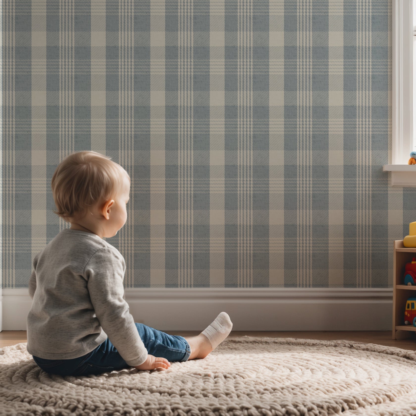 Blue checkered wallpaper with a modern plaid design in a playroom, featuring a young child seated on a soft rug in front of the wall