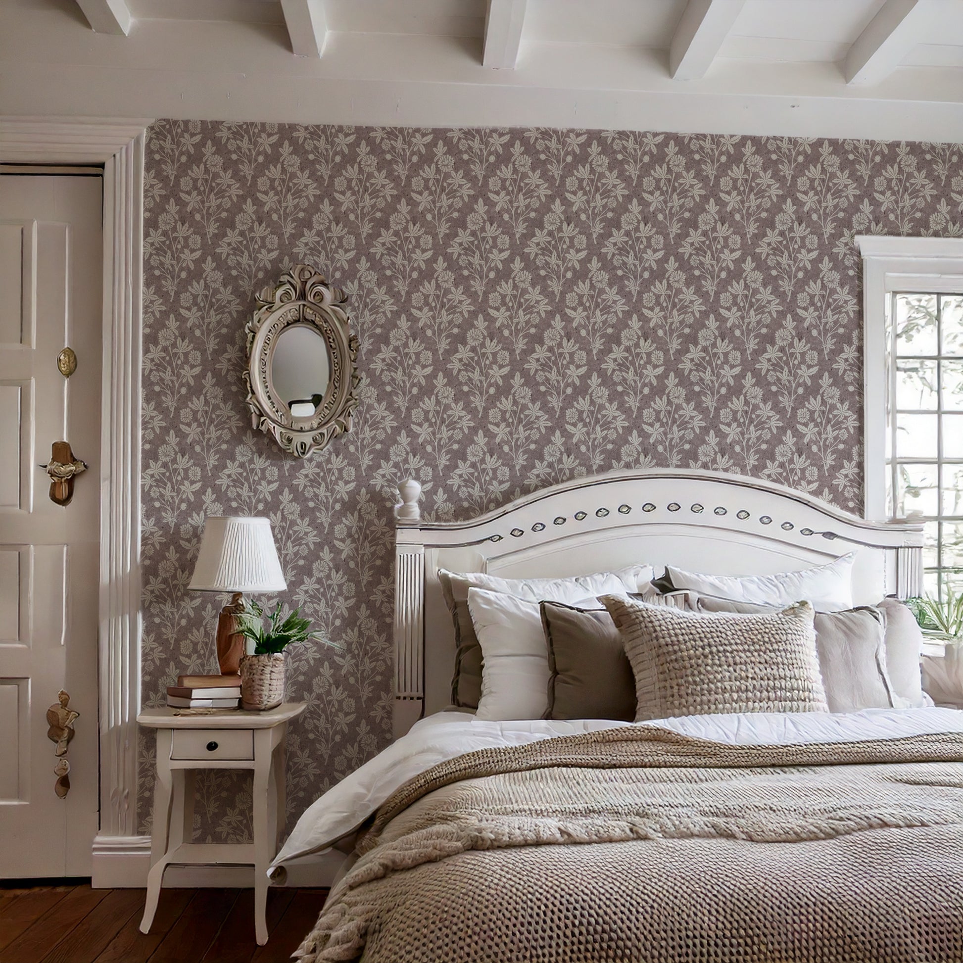 Cottage-style bedroom with ceiling beams and burgundy block print wallpaper featuring floral and geometric pattern.
