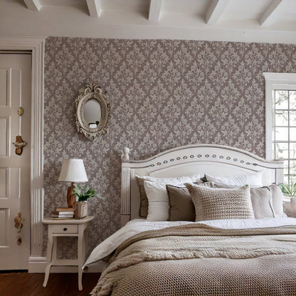 Cottage-style bedroom with ceiling beams and burgundy block print wallpaper featuring floral and geometric pattern.