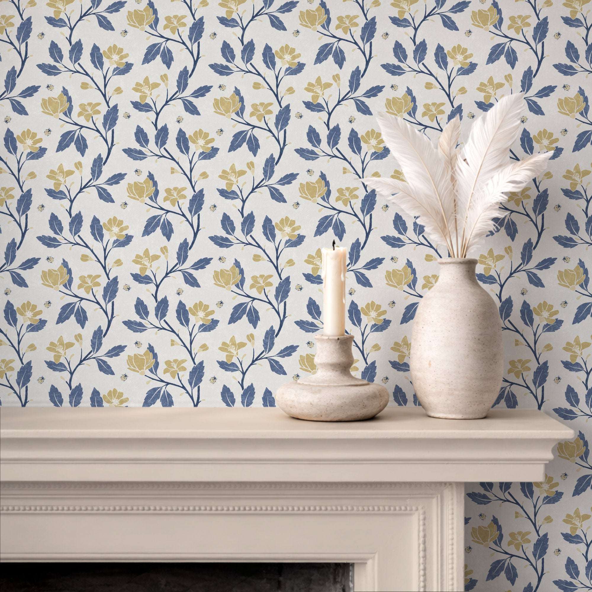 Floral vine wallpaper with blue leaves and yellow blooms, repeating ladybirds on pale background