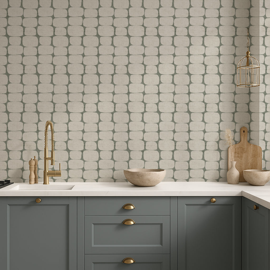 Modern geometric wallpaper in a kitchen with gray cabinets, white countertop, and patterned wall.