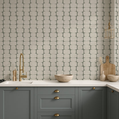 Modern geometric wallpaper in a kitchen with gray cabinets, white countertop, and patterned wall.