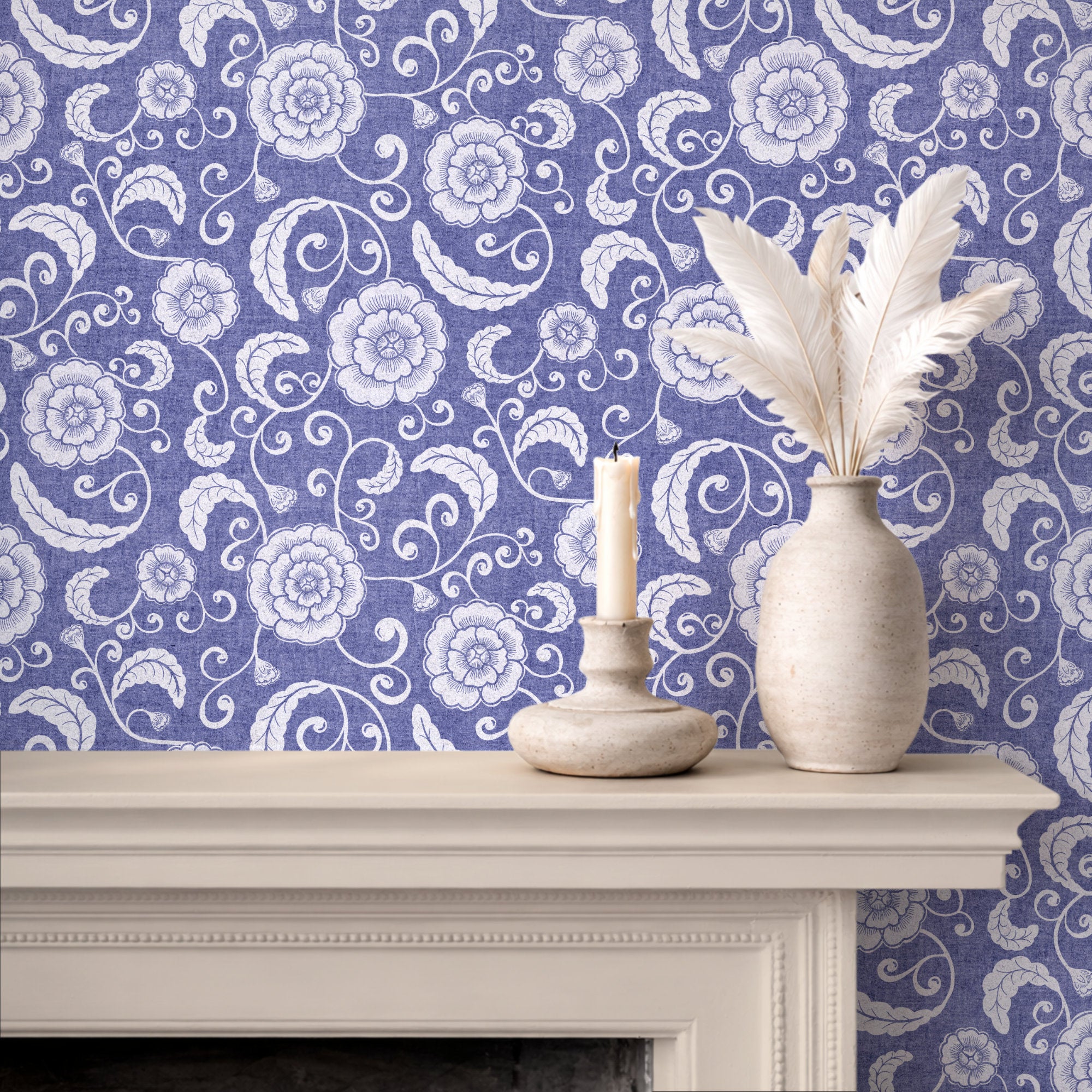 Blue and white ginger jar wallpaper pattern styled behind a white fireplace mantel with a textured vase of white feathers and a candle holder.